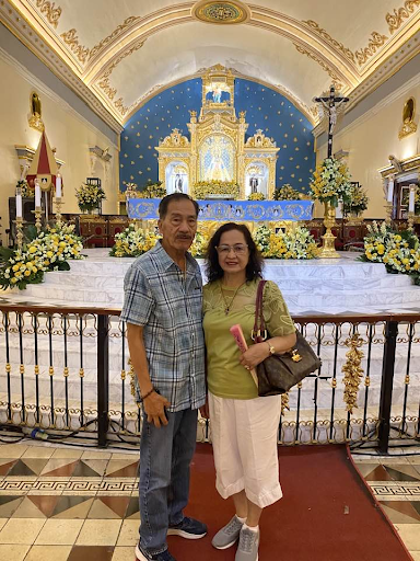 Salvacion Peralta and her husband, Julio, in front of the sanctuary of the Minor Basilica of Our Lady of the Holy Rosary of Manaoag in Pangasinan, Philippines. | Credit: Photo courtesy of Salvacion Peralta