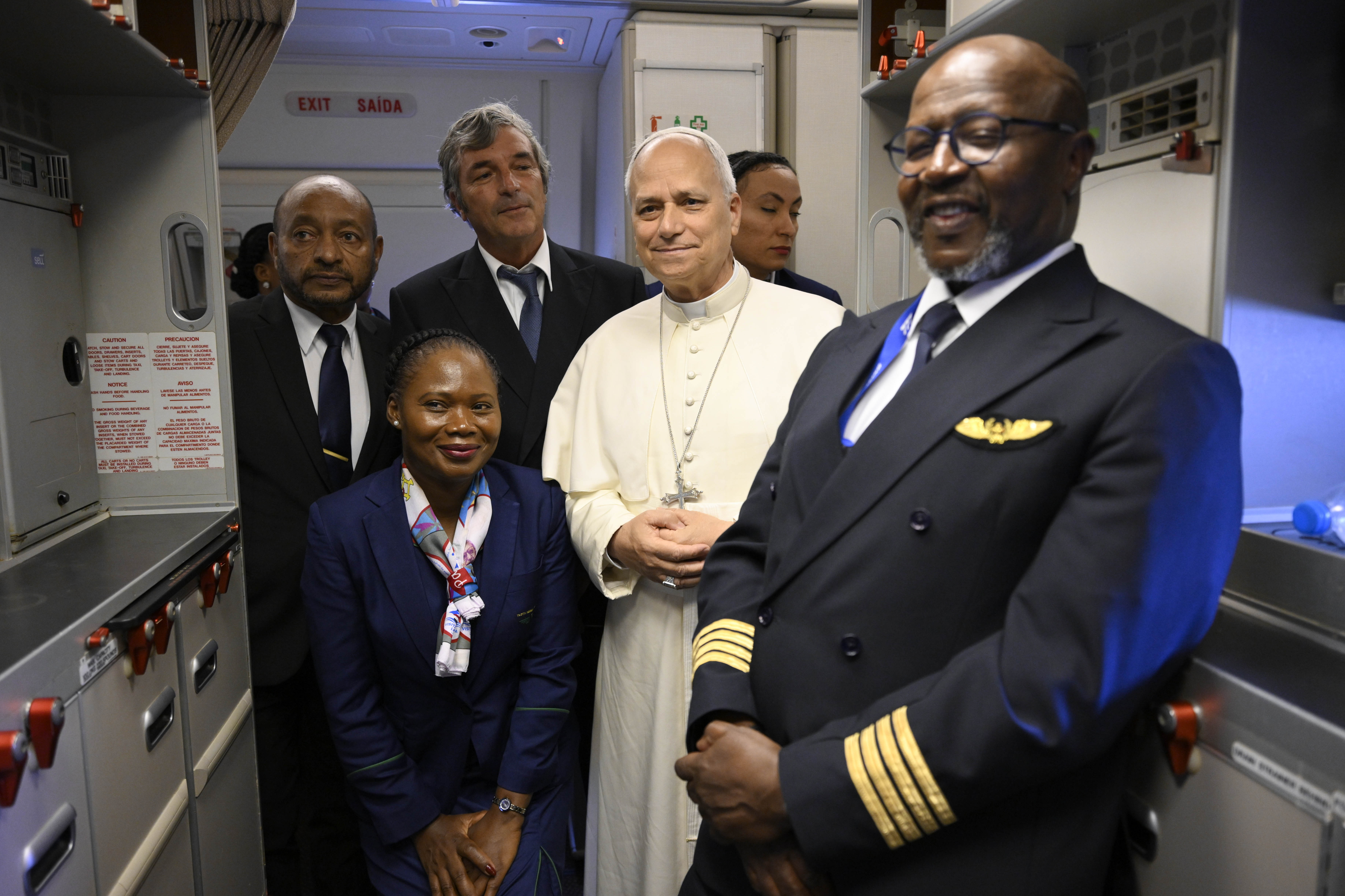 Pope Leo XIV stands with airline staff en route to Mengomeyén, Equatorial Guinea, Wednesday, April 22, 2026. | Credit: Vatican Media