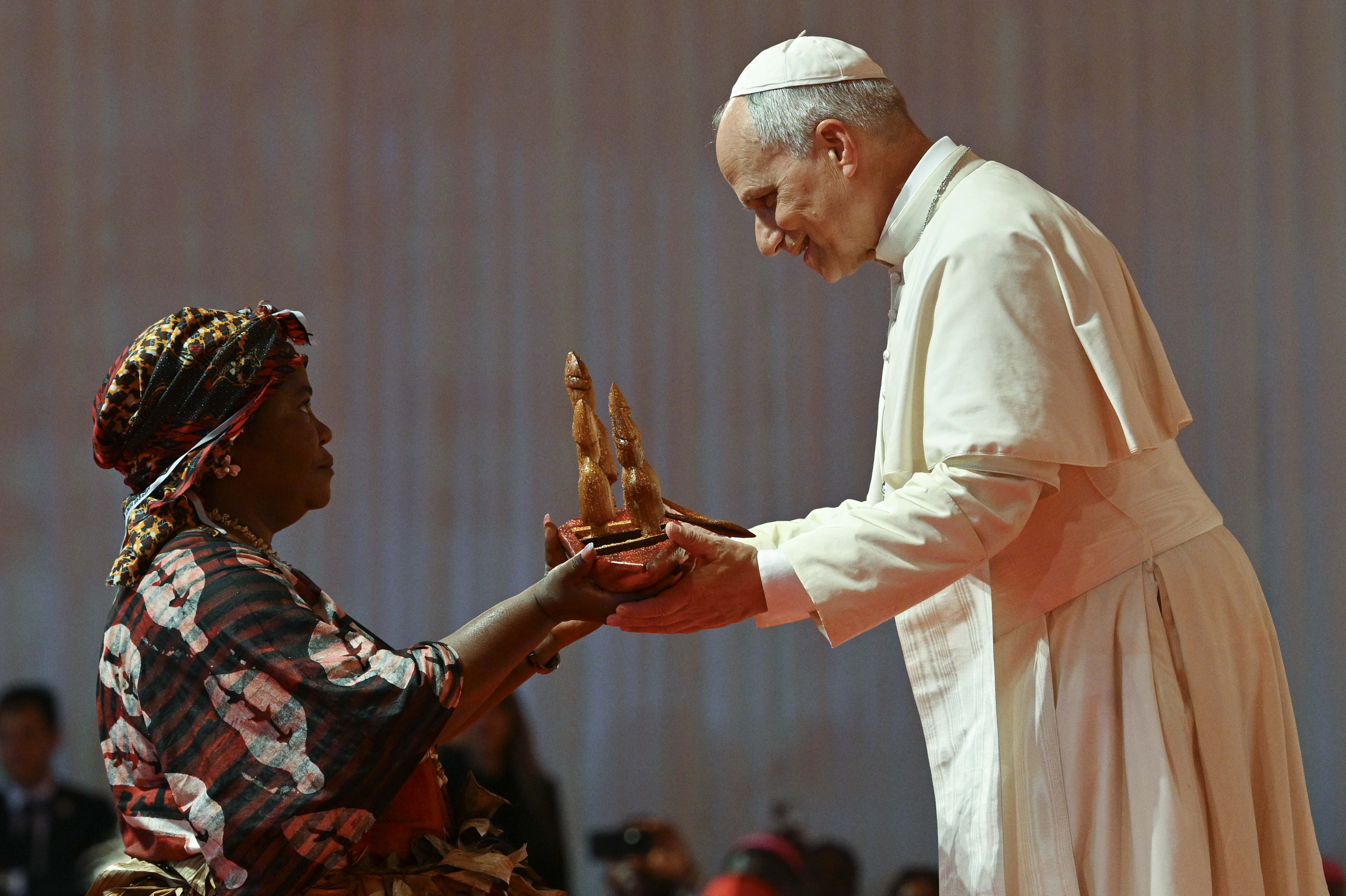 Pope Leo XIV receives a gift from a woman while meeting with families at Bata Stadium in Equatorial Guinea, Wednesday, April 22, 2026. | Credit: Vatican Media