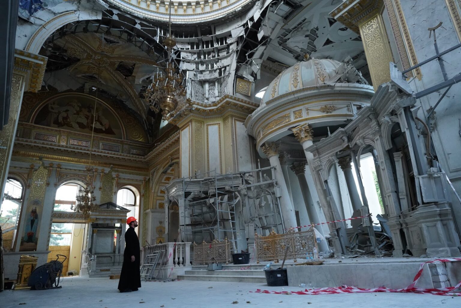 A Ukrainian Orthodox priest surveys damage to the Transfiguration Cathedral in Odesa following a Russian missile attack on July 23, 2023. | Credit: Valentyn Kuzan/war.ukraine.ua