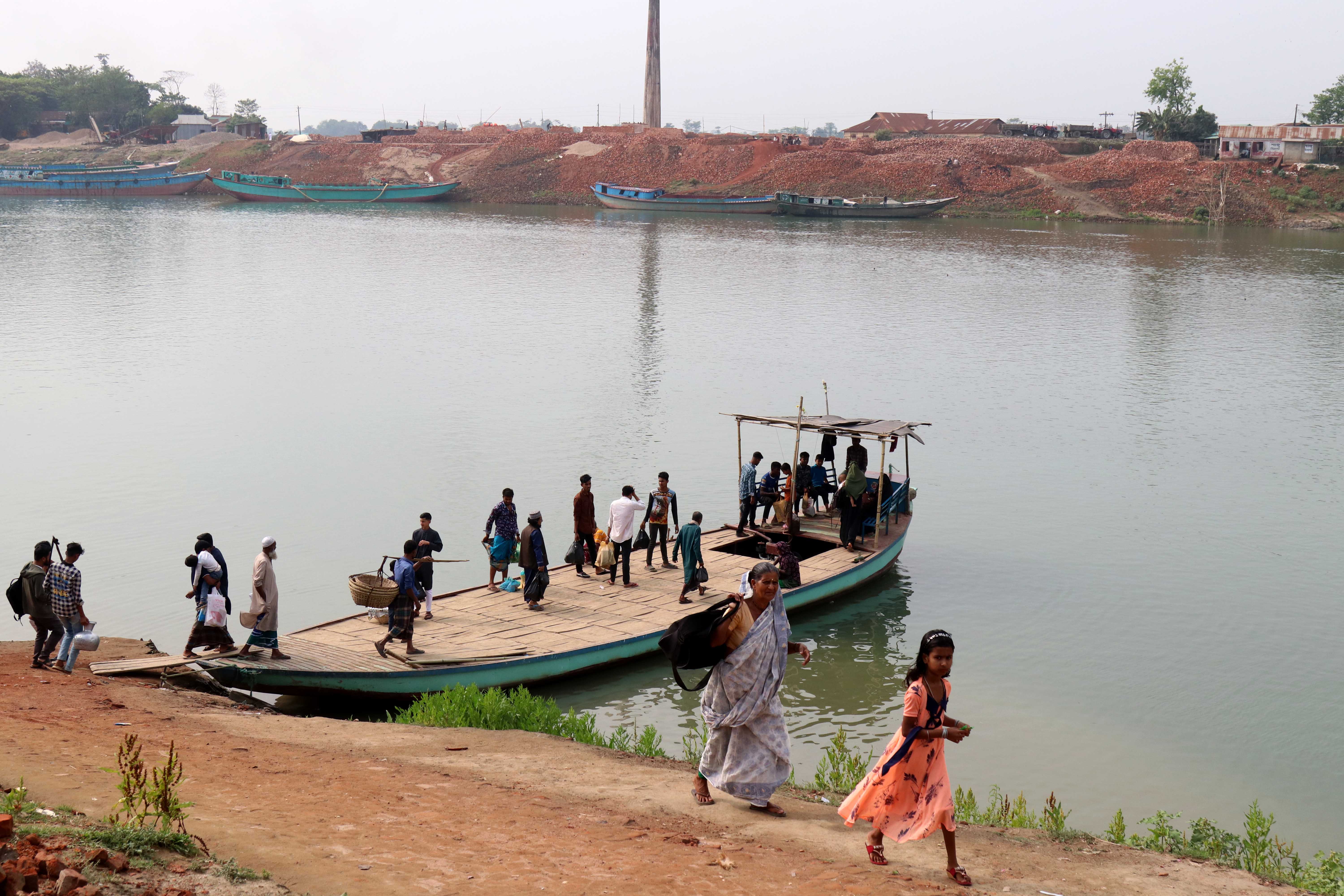 Passengers board a ferry to cross the Surma River near Jamalganj in Bangladeshʼs Sunamganj district. | Credit: Stephan Uttom Rozario/EWTN News