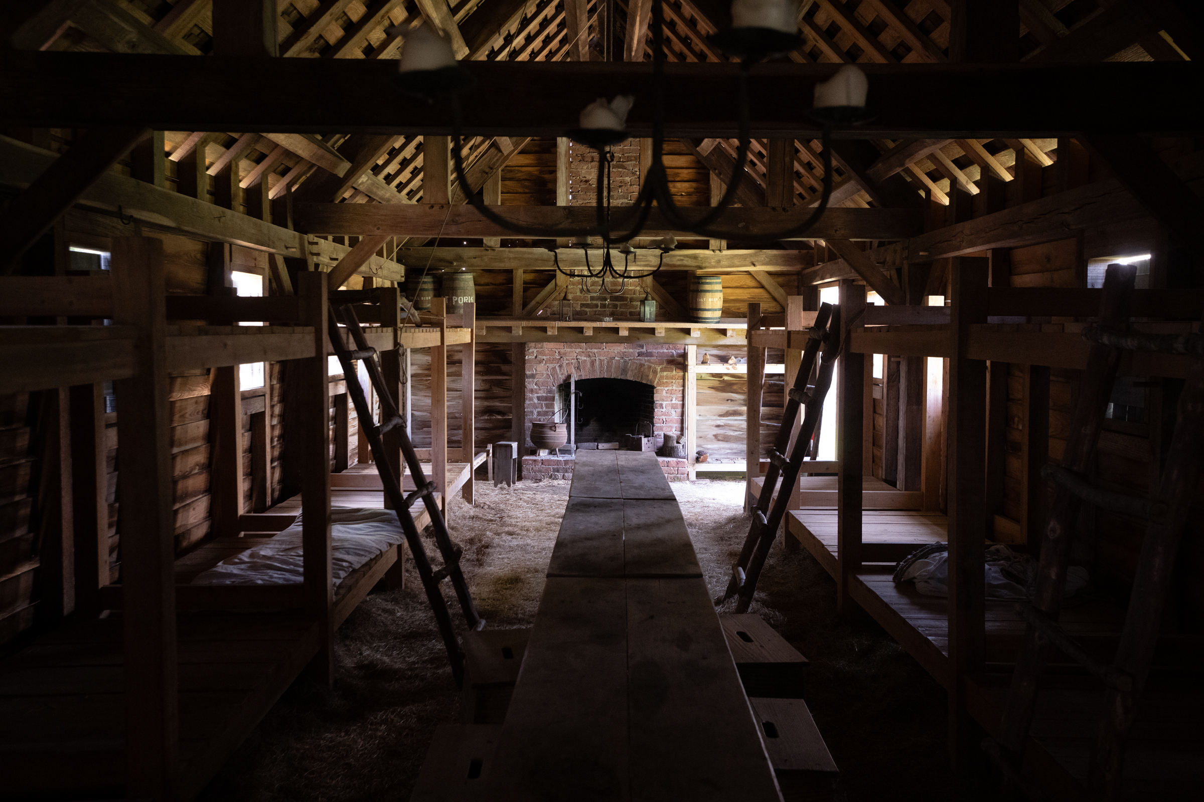 A reconstructed barracks interior at Fort King George State Historic Site shows bunks, a hearth, and sparse living conditions at the colonial outpost. | Credit: Jeffrey Bruno
