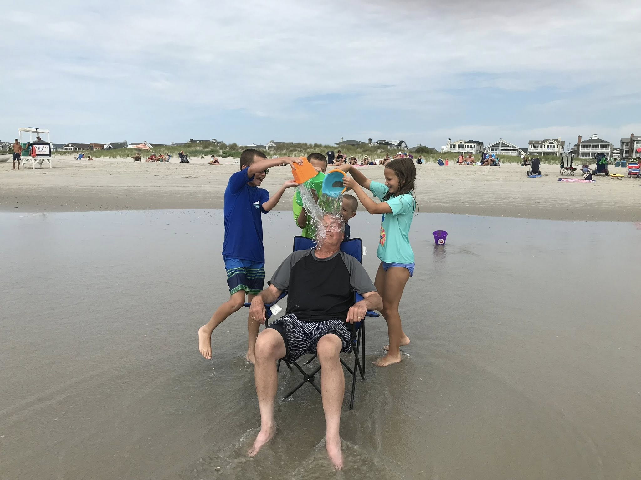 Charles Zech plays with his grandchildren at the beach in an undated photo. | Credit: Photo courtesy of the Zech family