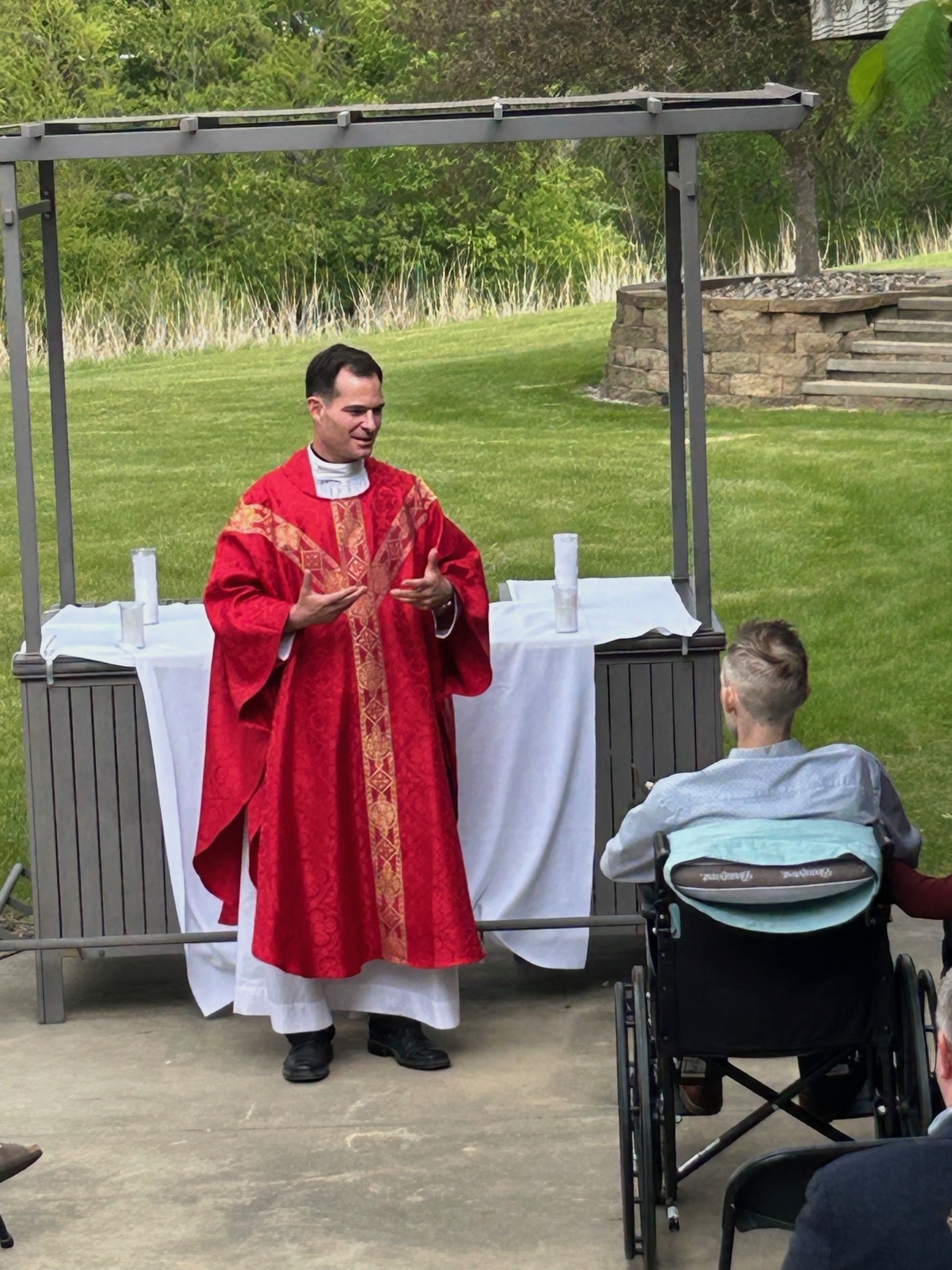 Benedictine College chaplain Father Ryan Richardson speaks “directly” to Alex Lynch at his personal baccalaureate Mass on May 7, 2026. | Credit: Photo courtesy of Father Ryan Richardson