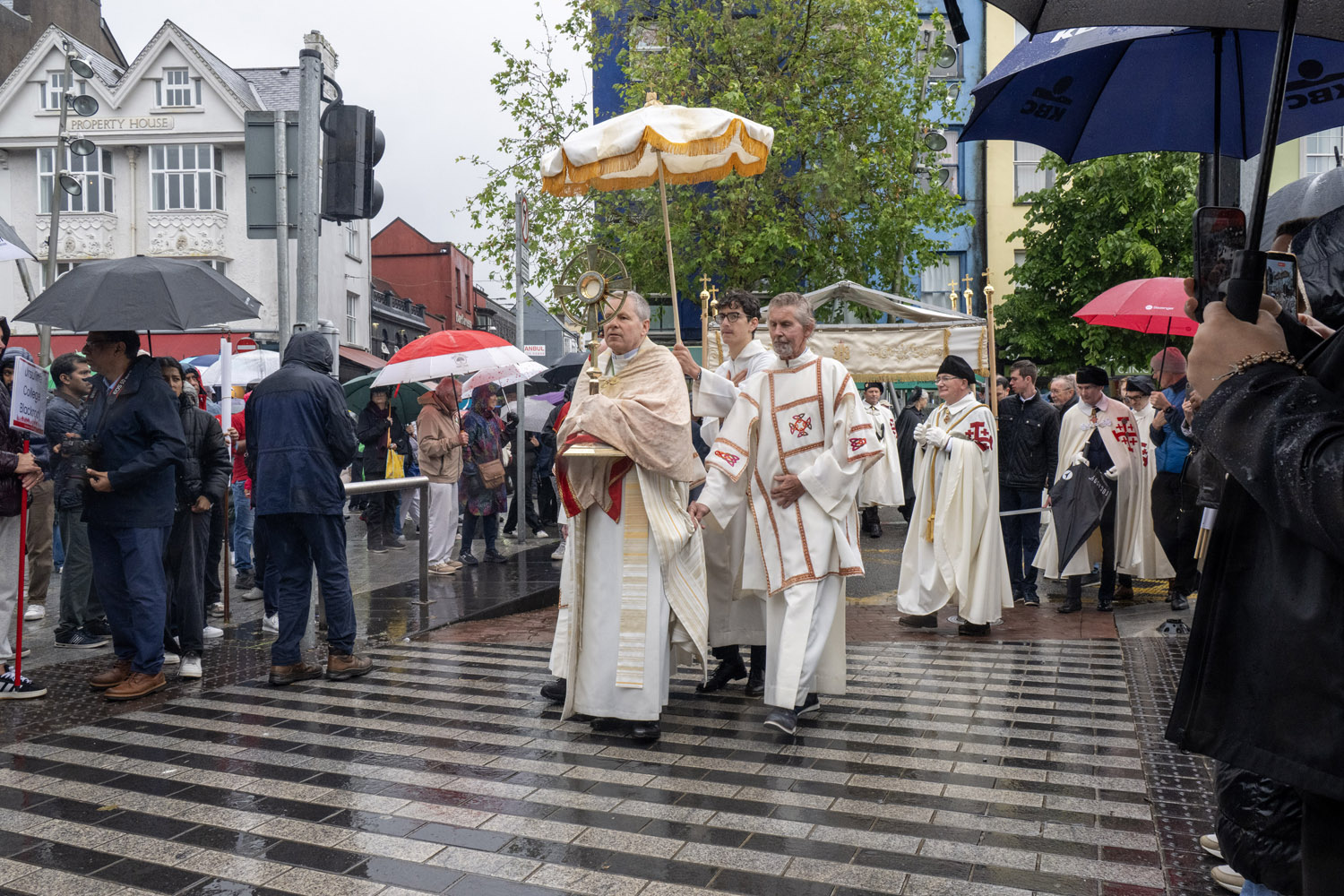 Thousands braved torrential rain on June 7, 2026, to take part in the 100th Eucharistic procession in Cork, Ireland. The procession is an established Cork tradition and made its way through the city from the North Cathedral to the Grand Parade, the vibrant heart of the city. | Credit: Brian Lougheed