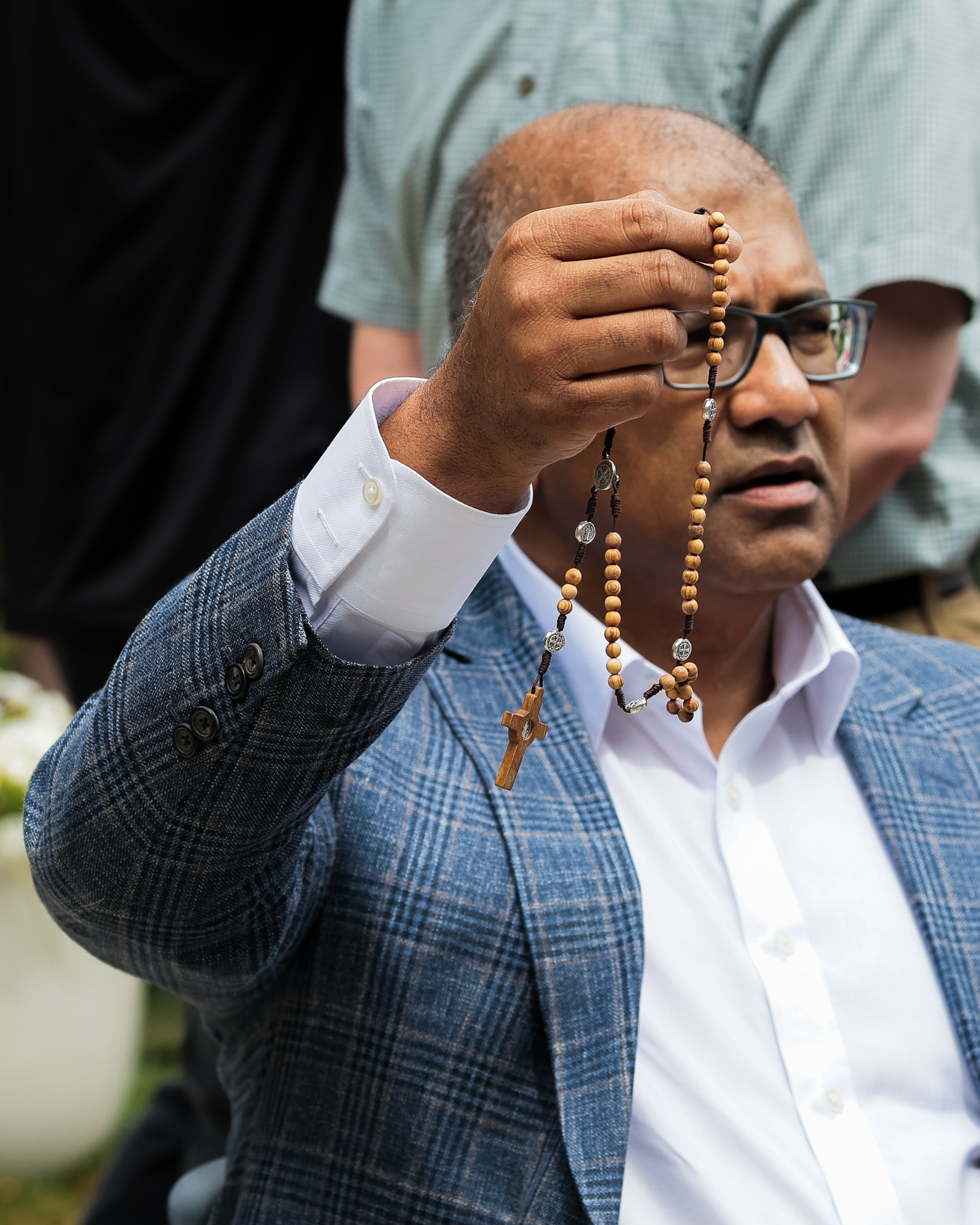 An attendee holds up his rosary at the opening of the Father Peyton Center at the family rosary. | Credit: Photo courtesy of Holy Cross Family Ministries
