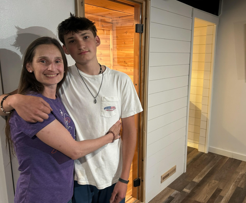 Becky Soltis and her son, Jake, in their basement, where Jake built a sauna and exercise room to aid in his motherʼs recovery. | Credit: Photo courtesy of the Soltis family