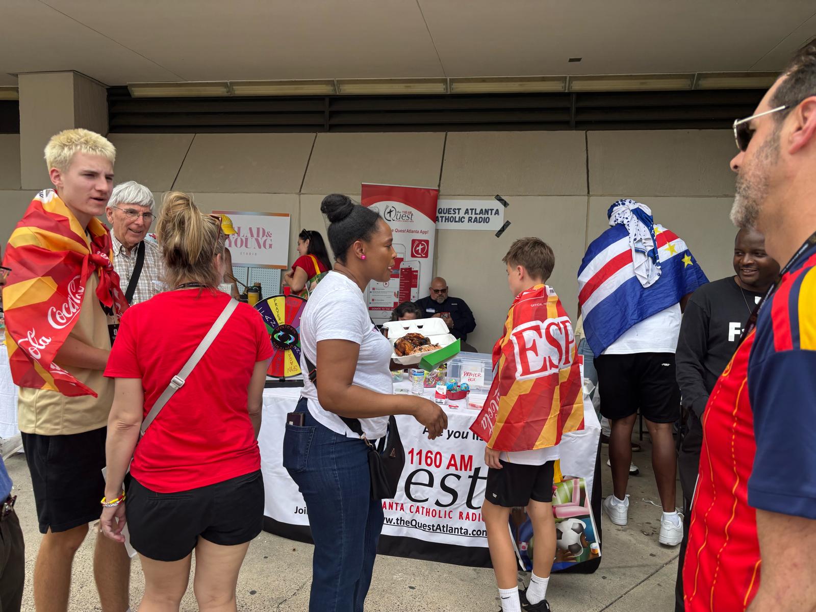World Cup visitors at The Quest Atlanta Catholic Radio hospitality booth in Atlanta. | Credit: Photo courtesy of The Quest Atlanta Catholic radio