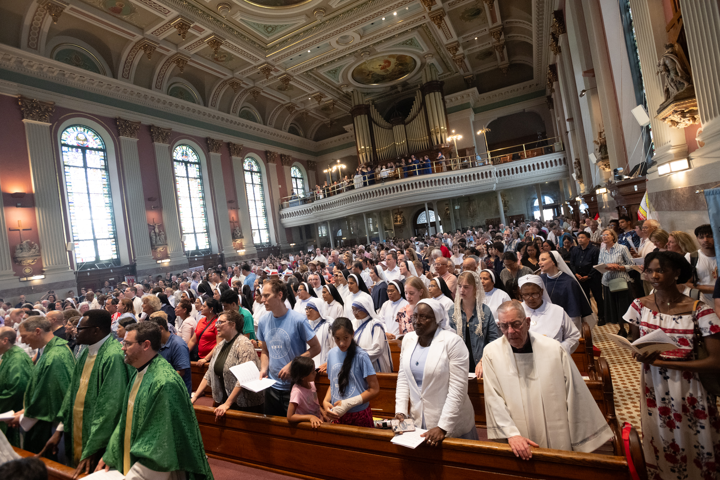 Clergy, religious sisters, and pilgrims stand inside the National Shrine of St. John Neumann following the Eucharistic procession through Philadelphia, Sunday, July 5, 2026. | Credit: Jeffrey Bruno