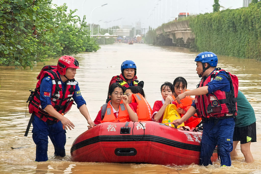 Rescue workers evacuate flood-affected students in Guigang, in China’s southern Guangxi region, on July 8, 2026. | Credit: CN-STR/AFP via Getty Images