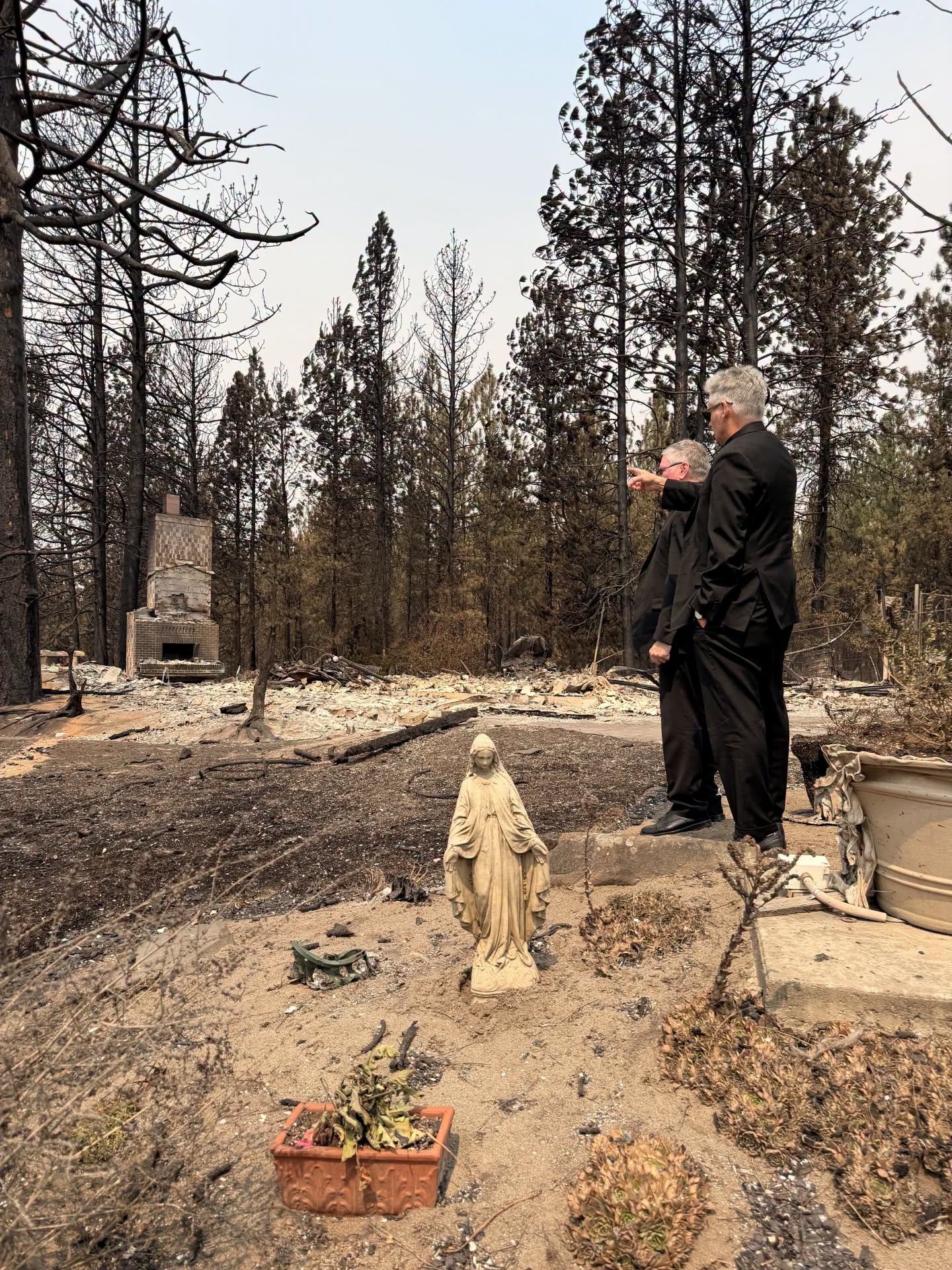 Spokane Bishop Thomas Daly surveys fire damage as a statue of the Blessed Mother stands nearby in Spokane, Washington, Aug. 3, 2026. | Credit: Diocese of Spokane