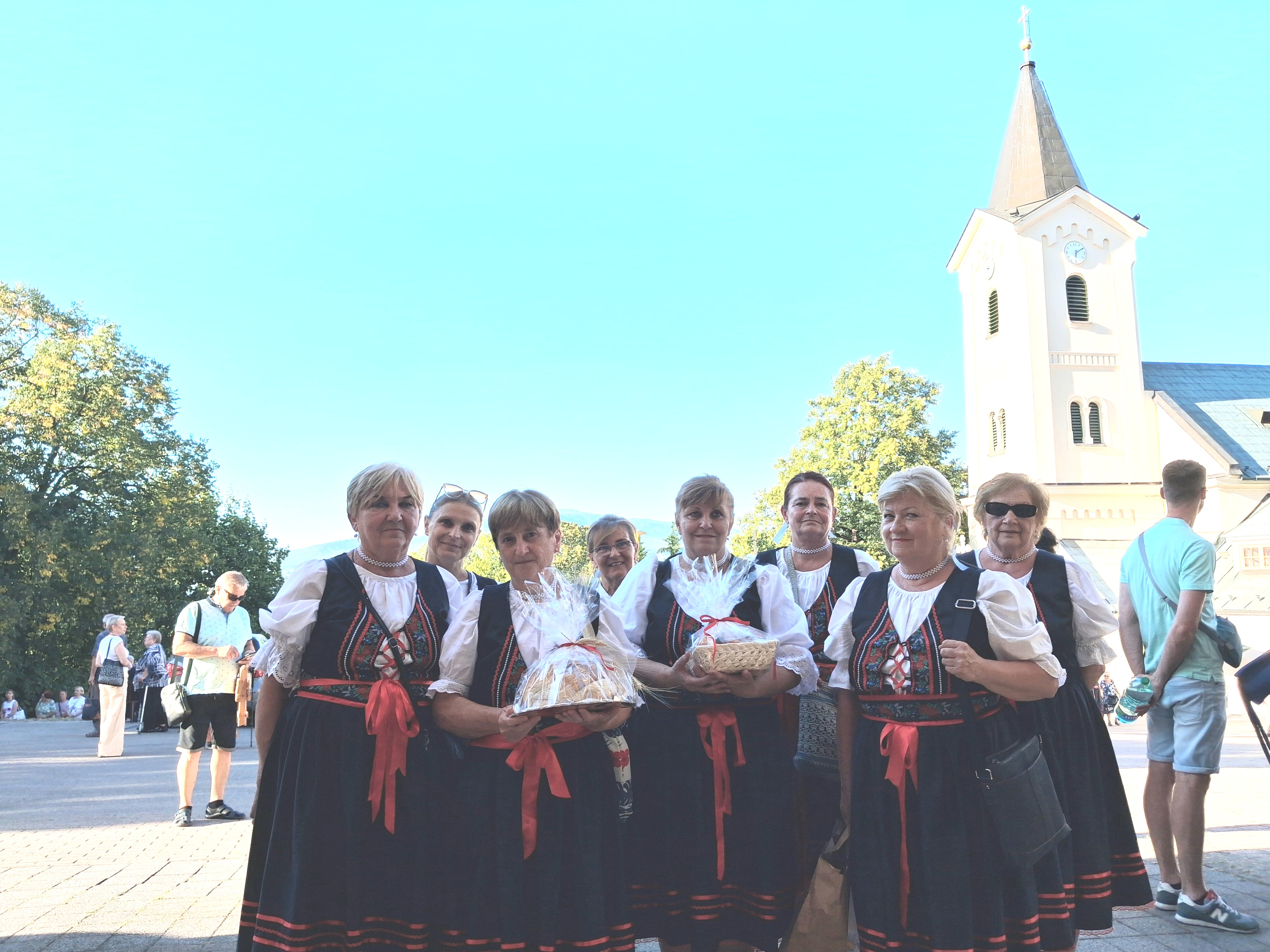 Women in traditional Slovak dress carry baskets of bread at the Assumption pilgrimage in Nitra, Slovakia, on Aug. 15, 2026. | Credit: Bohumil Petrík