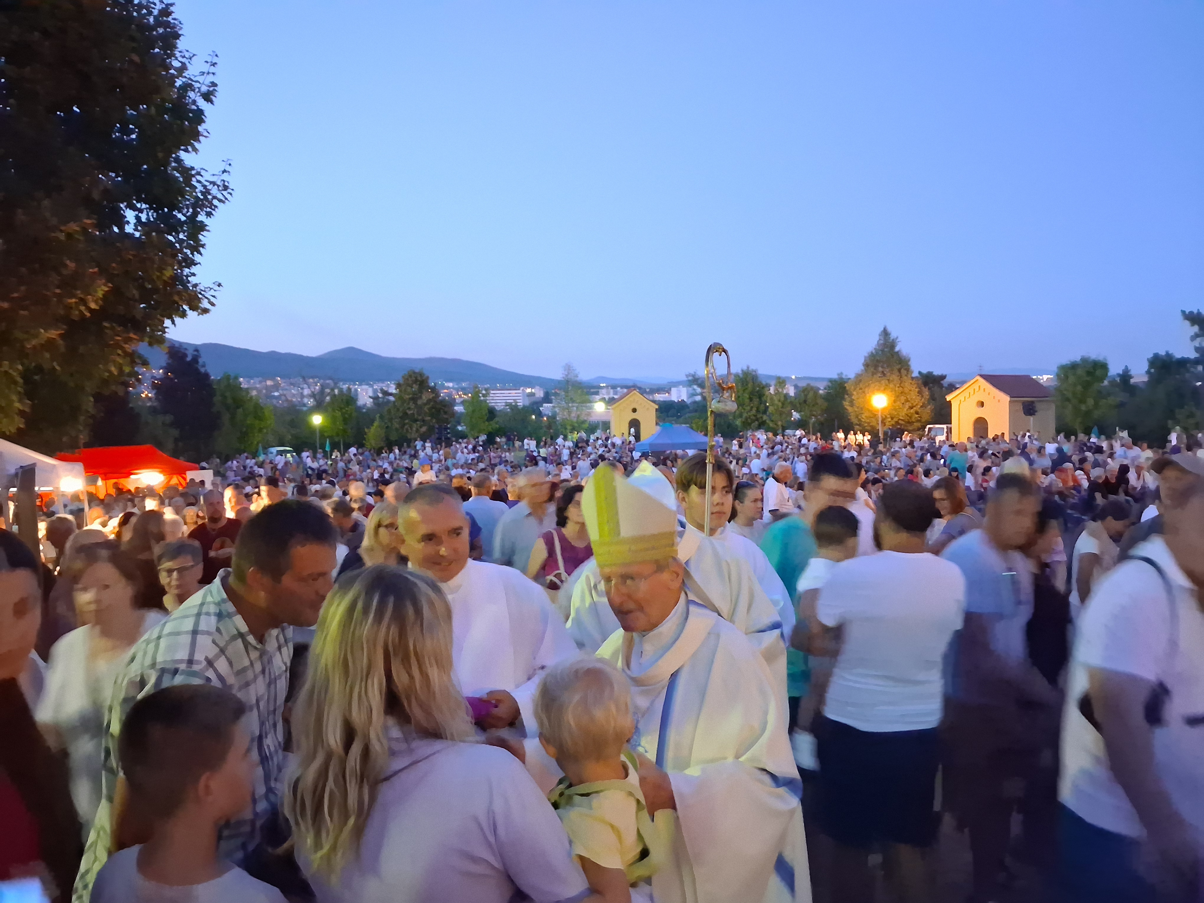 Bishop František Rábek blesses a child at the close of the evening liturgy on the Calvary hill in Nitra, Slovakia, on Aug. 15, 2026. | Credit: Bohumil Petrík