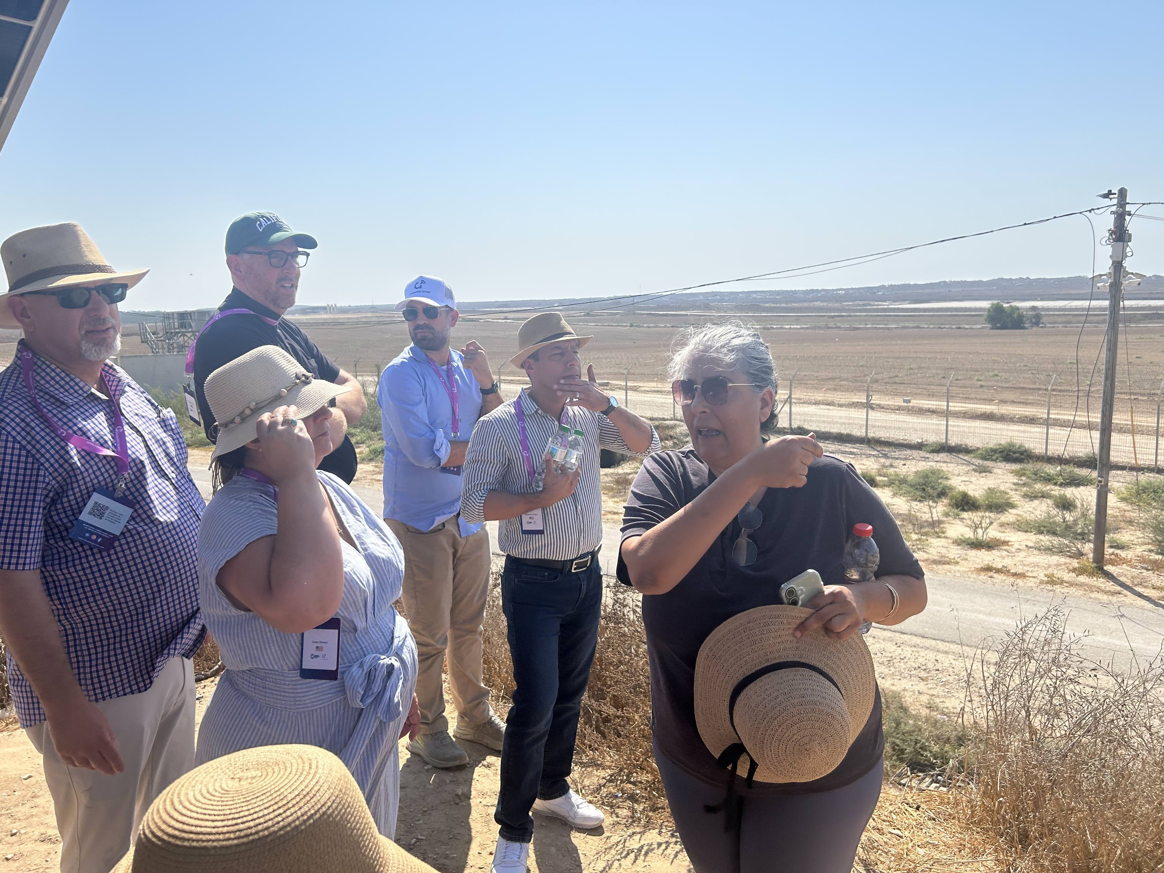 Members of the delegation survey the Gaza Strip, accompanied by Oct. 7, 2023, survivor Oshrit Sabag (pointing over her shoulder) of the neighboring Nahal Oz kibbutz. | Credit: Ken Oliver-M�ndez/EWTN News