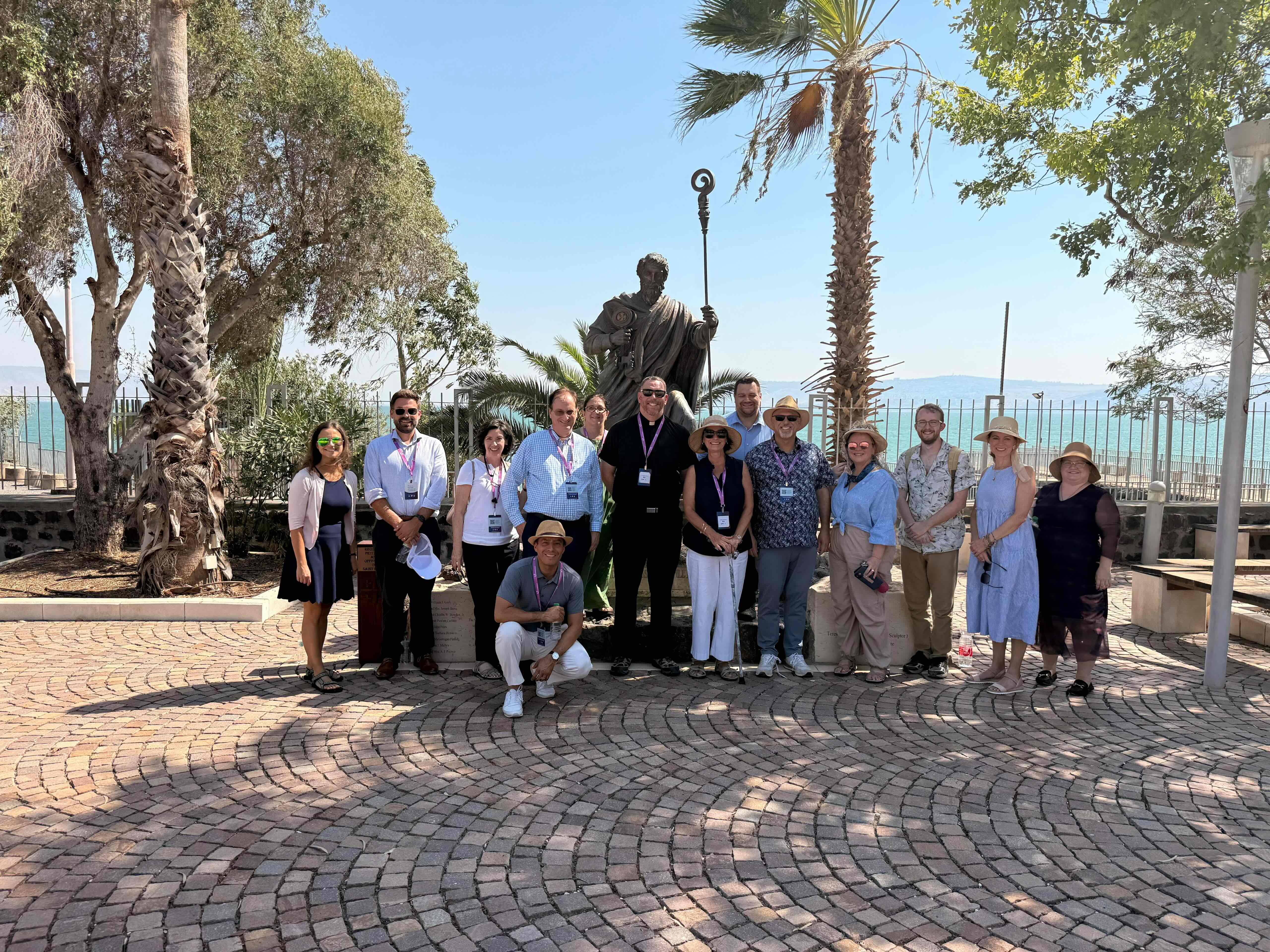 With St. Peter's statue towering above them, members of the delegation are seen here in Capernaum, the fishing village that was the primary base of operations of Jesus' ministry in Galilee and home of the Chief of the Apostles. | Credit: Photo courtesy of Yosi Shoshani