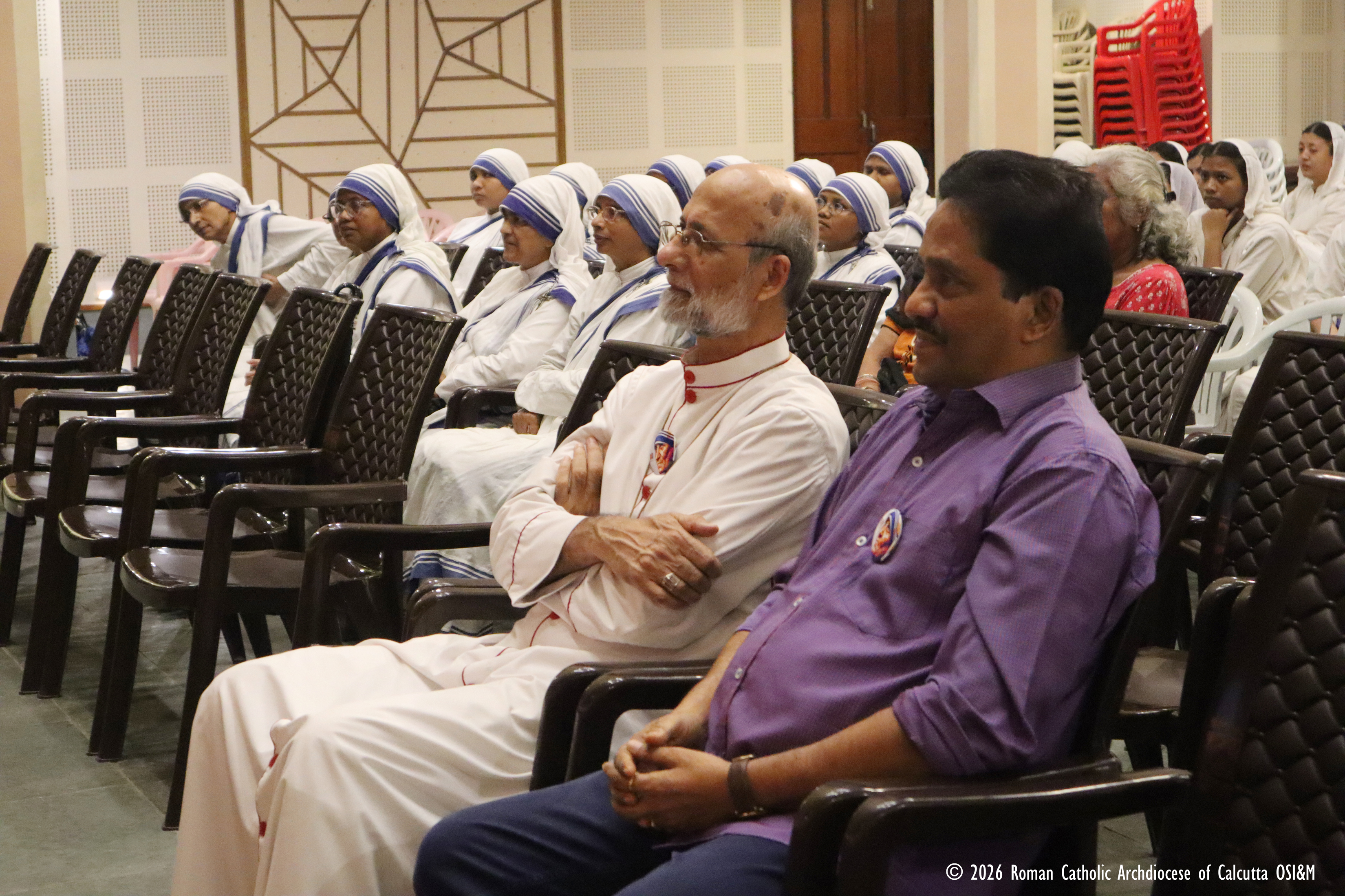 Archbishop Elias Frank of Kolkata sits beside journalist and author Anto Akkara during the premiere of the new documentary 