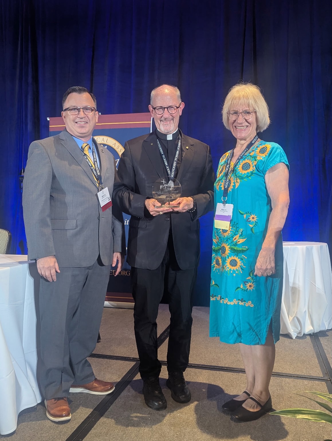 Bishop James Conley, center, receives the 2026 Evangelium Vitae award. He stands with Mario Dickerson, CMA executive director, left, and Dr. Mary Keen-Kirchoff, CMA conference chair, on Sept. 10, 2026. | Credit: Photo courtesy of Catholic Medical Association