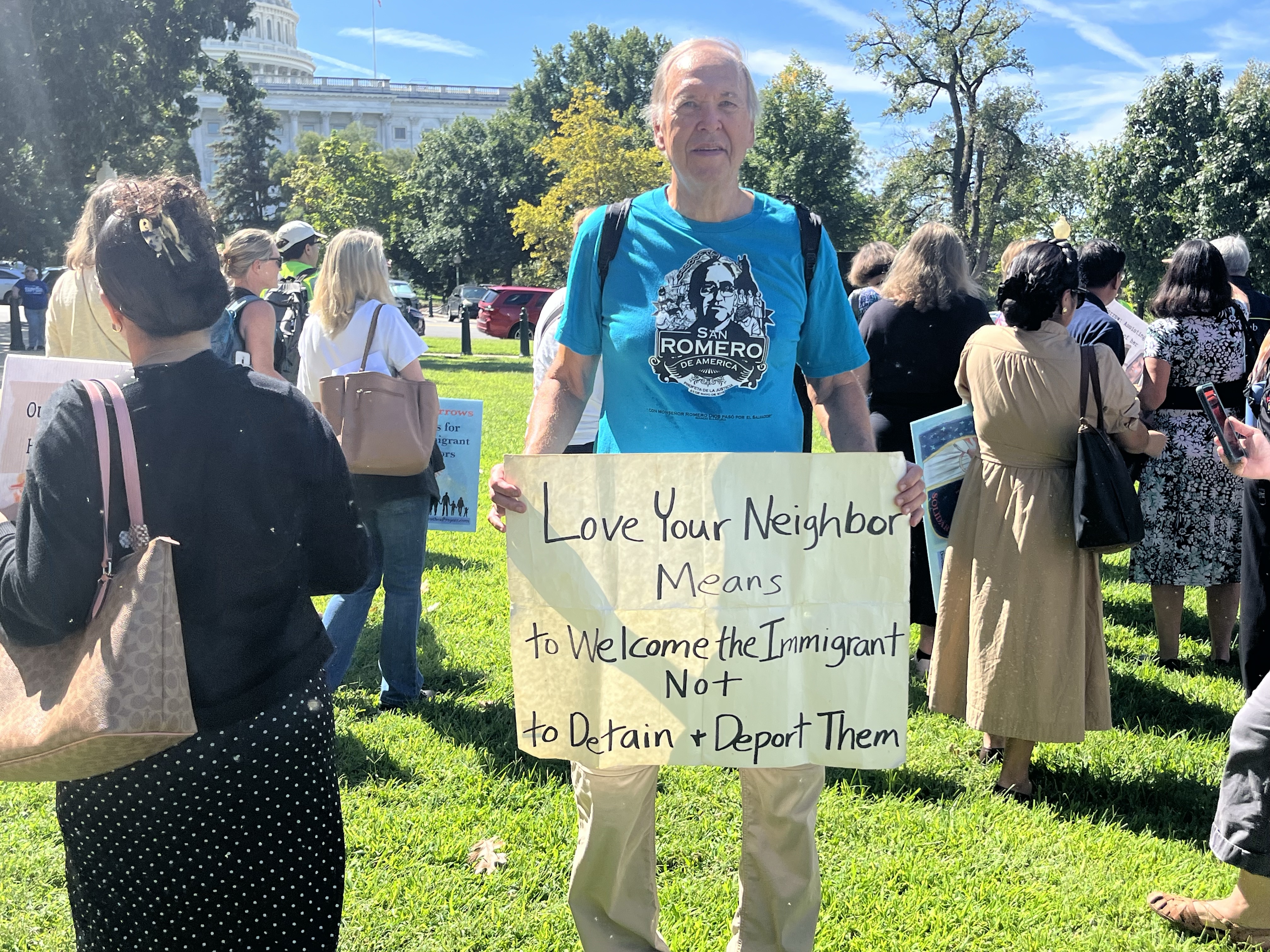 Art Laffin, a member of the Dorothy Day Catholic Worker movement in Washington, D.C., holds sign at a procession in Washington, D.C., to show solidarity with migrants on Sept. 15, 2026, organized by the Dorothea Project. | Credit: Tyler Arnold/EWTN News
