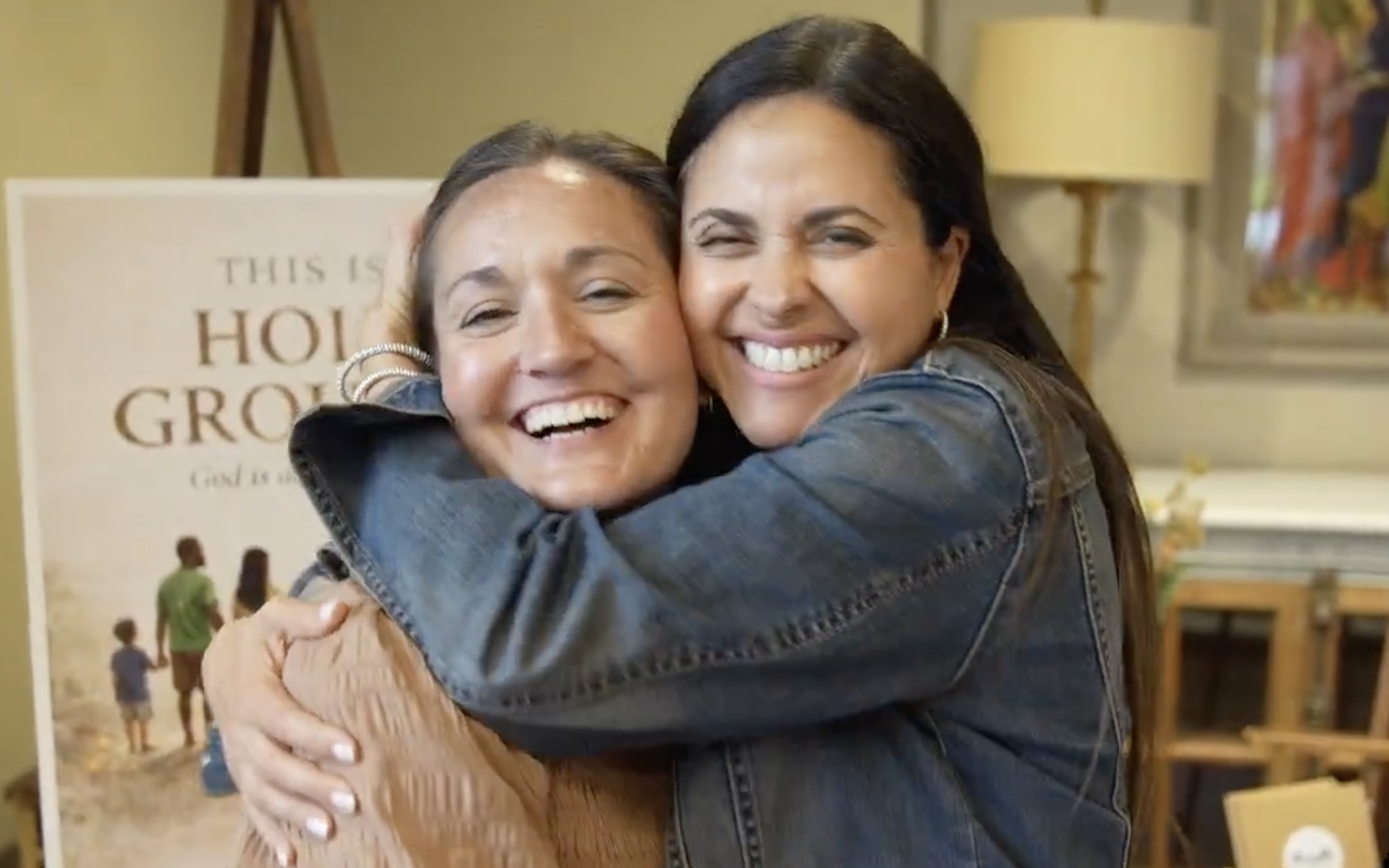 Jodi Devore and Edda Dupaquier hug at a family retreat. | Credit: Photo courtesy of All Are Welcome