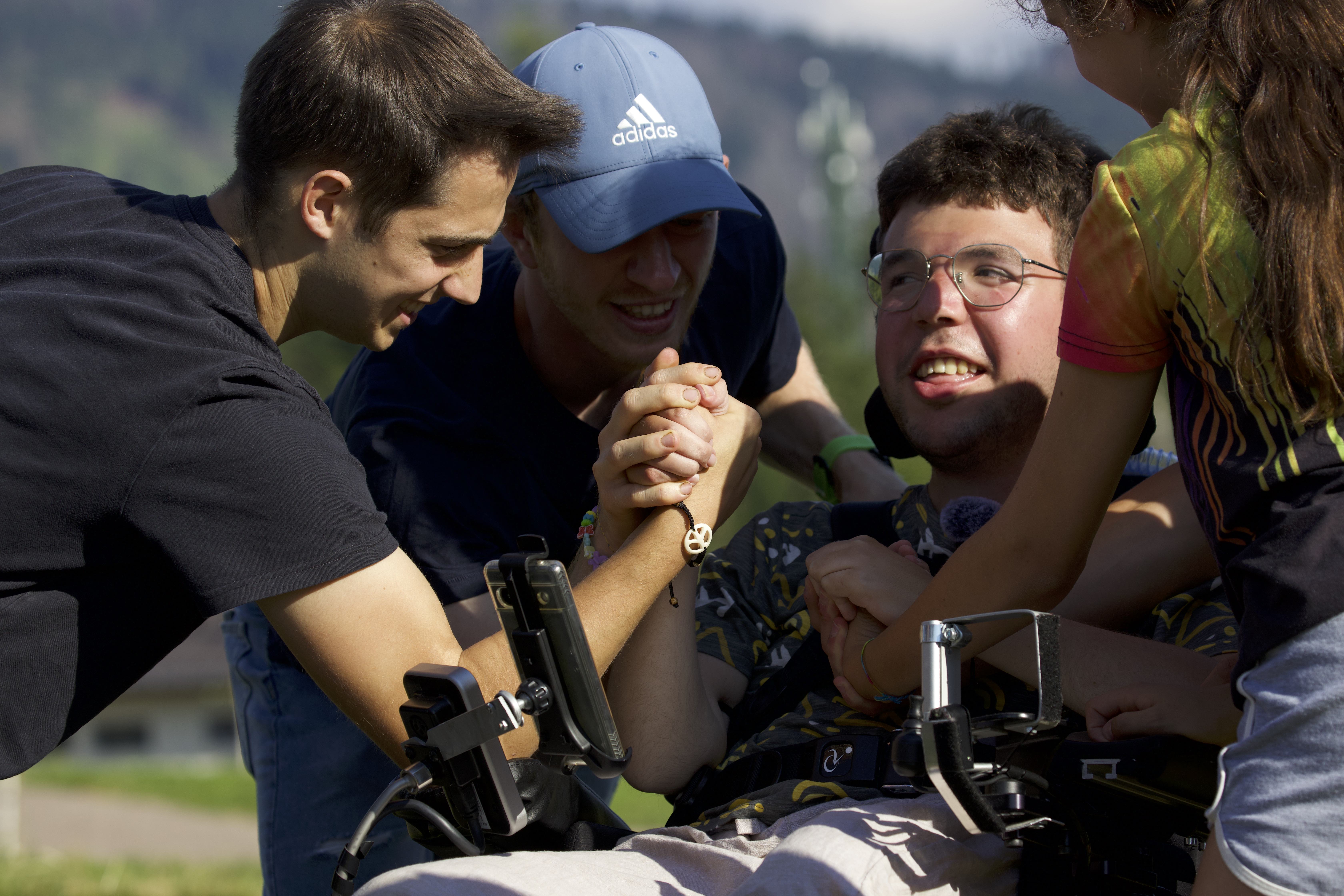 Giacomo Mattivi, EL joven italiano que padece distrofia muscular de Duchenne, rodeado de sus amigos. Crédito: Un fotograma de la cinta cedida por Green Lava.