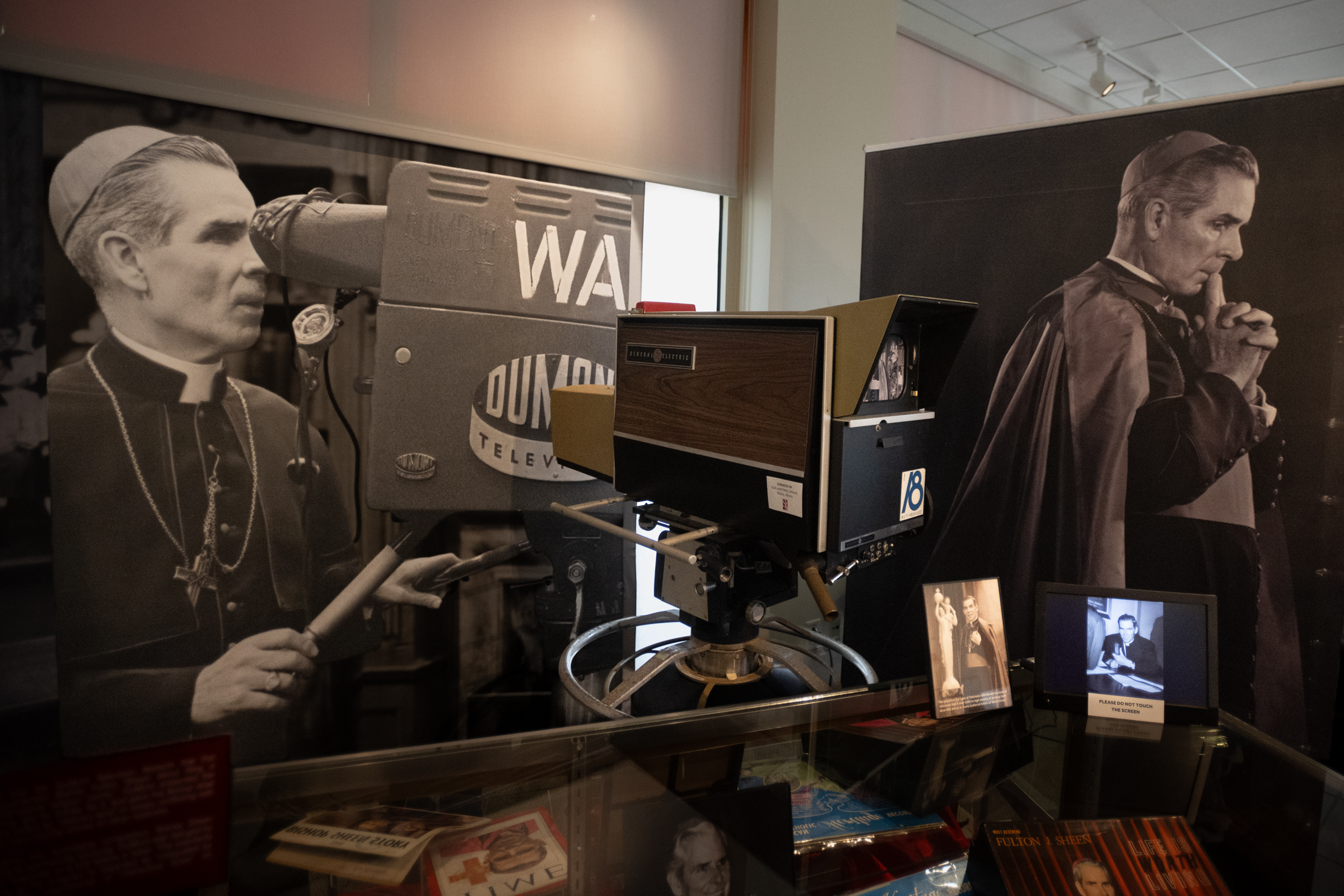 A display at the Archbishop Fulton Sheen Museum recalls Sheenʼs pioneering work in television evangelization, with images of the archbishop beside a vintage television camera. | Credit: Jeffrey Bruno