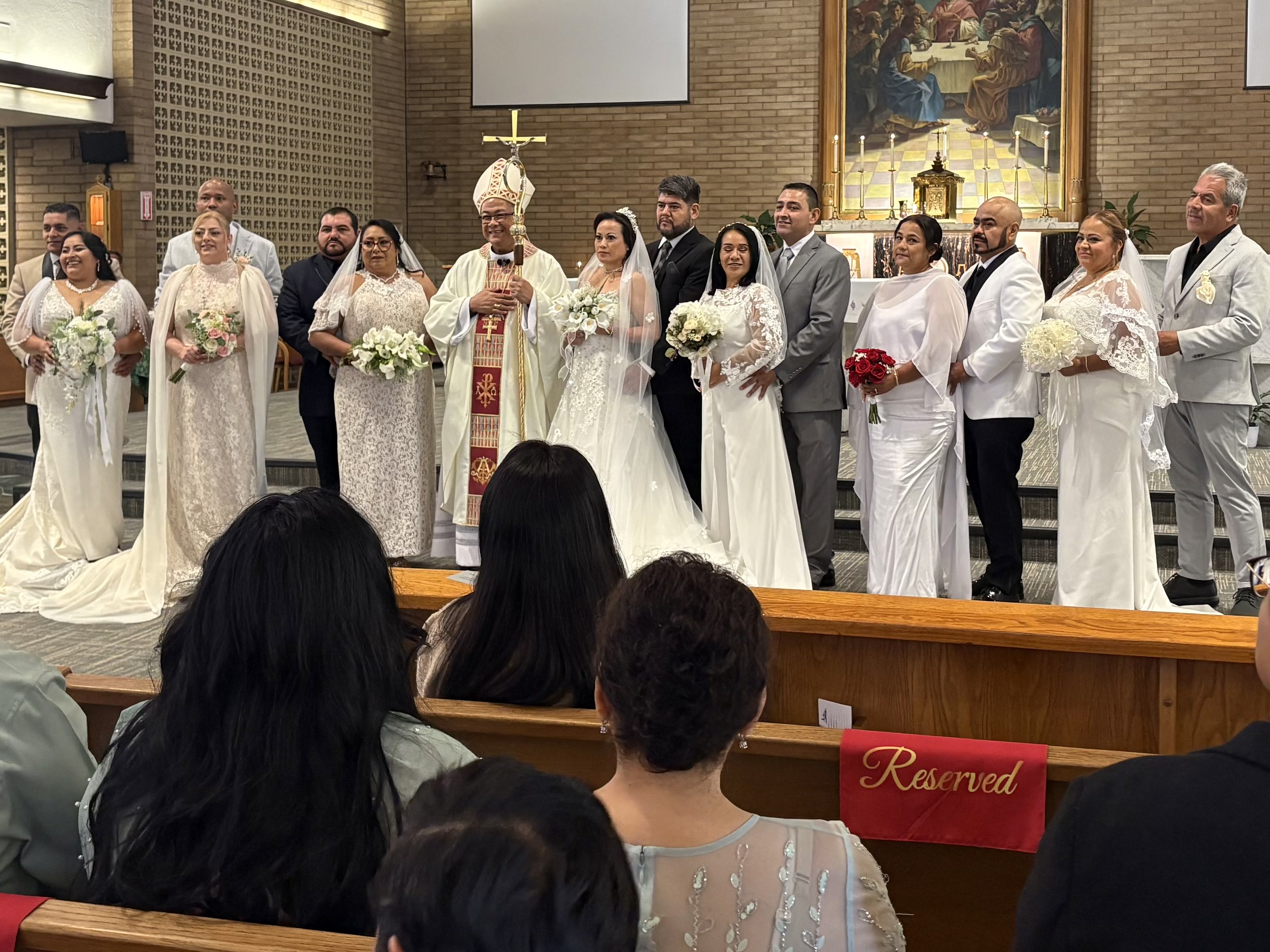 Participating couples pose for photos in the sanctuary during a Radiate Love communal convalidation liturgy presided over by San Jose Bishop Oscar Cantú and clergy. | Credit: Oliver Tapia/Diocese of San Jose