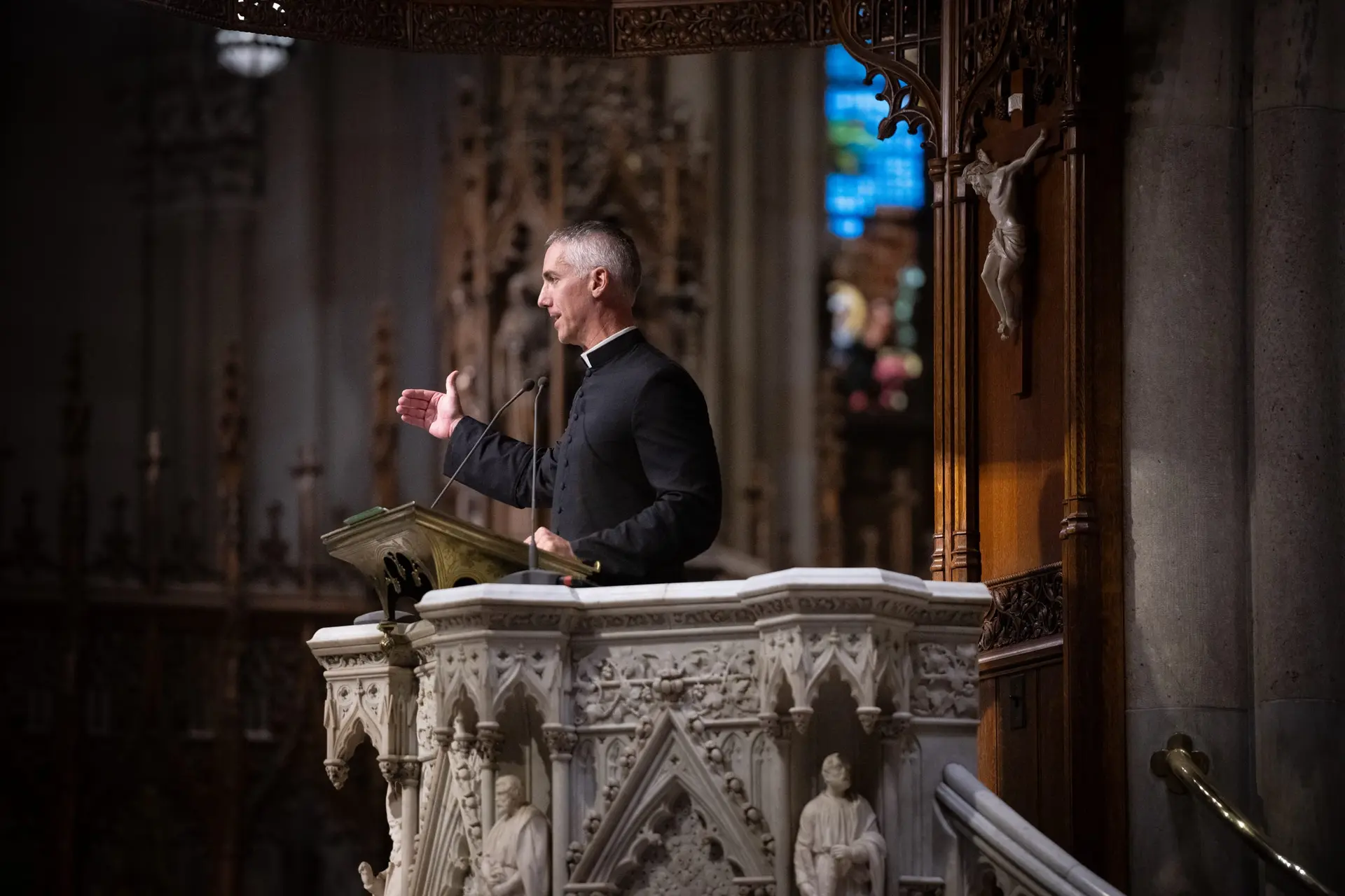 Father John Burns offers a reflection beneath the crucifix. Before we follow Christ into the streets, we make room to hear Him. | Credit: Jeffey Bruno