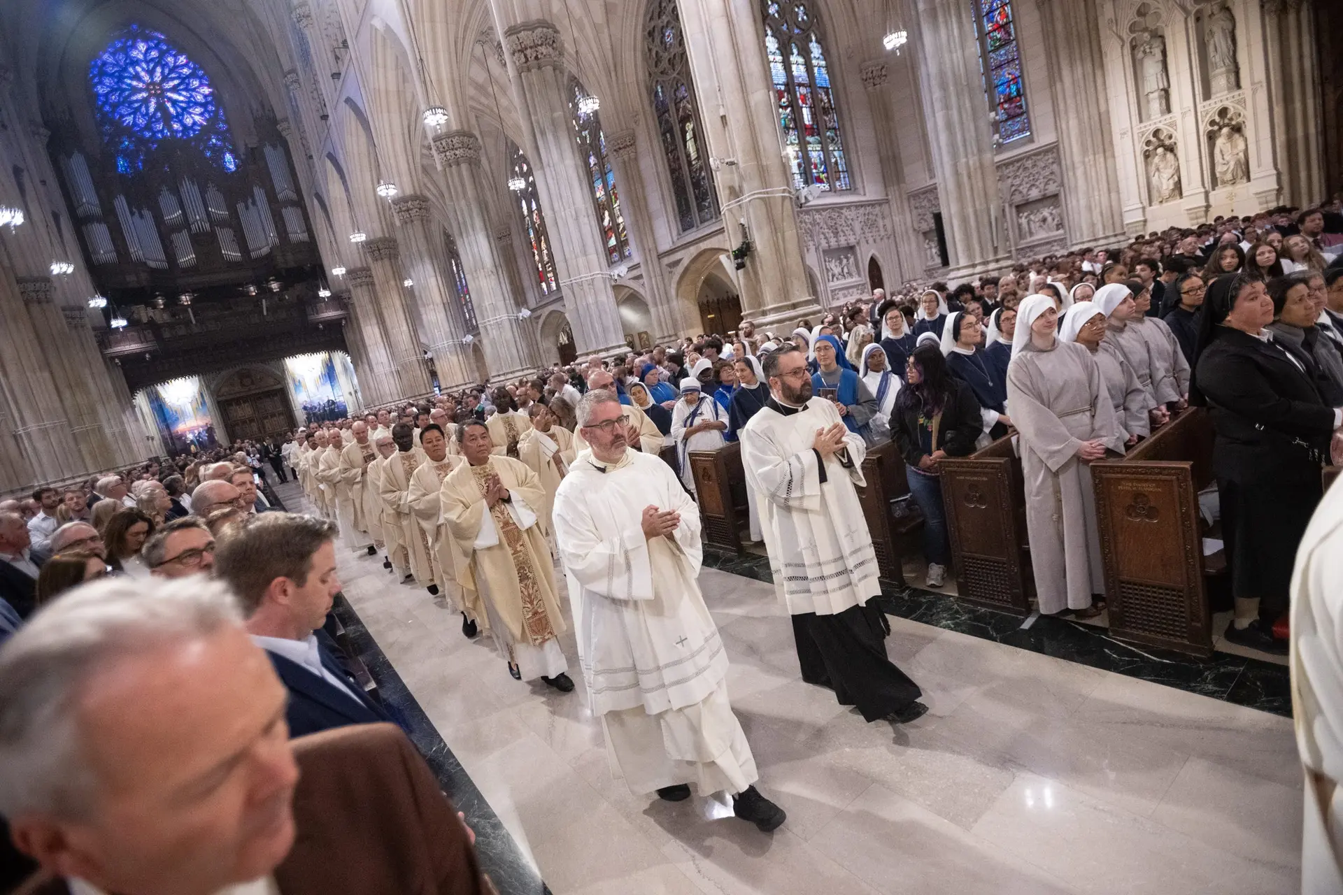 The priests make their way through a packed cathedral. So many lives, gathered around one altar. | Credit: Jeffrey Bruno