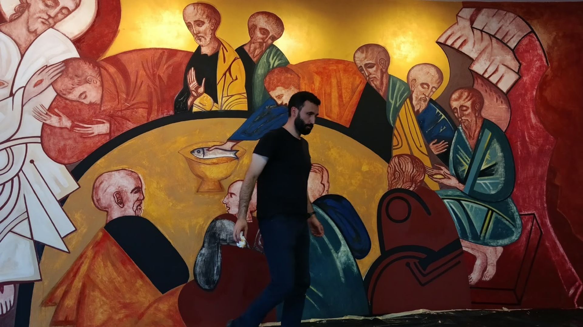Father Andrii Stebivka, a priest of the Greek Catholic Eparchy of Mukachevo, paints a Byzantine-style mural in a Ukrainian parish. | Credit: Photo courtesy of the family of Father Andrii Stebivka