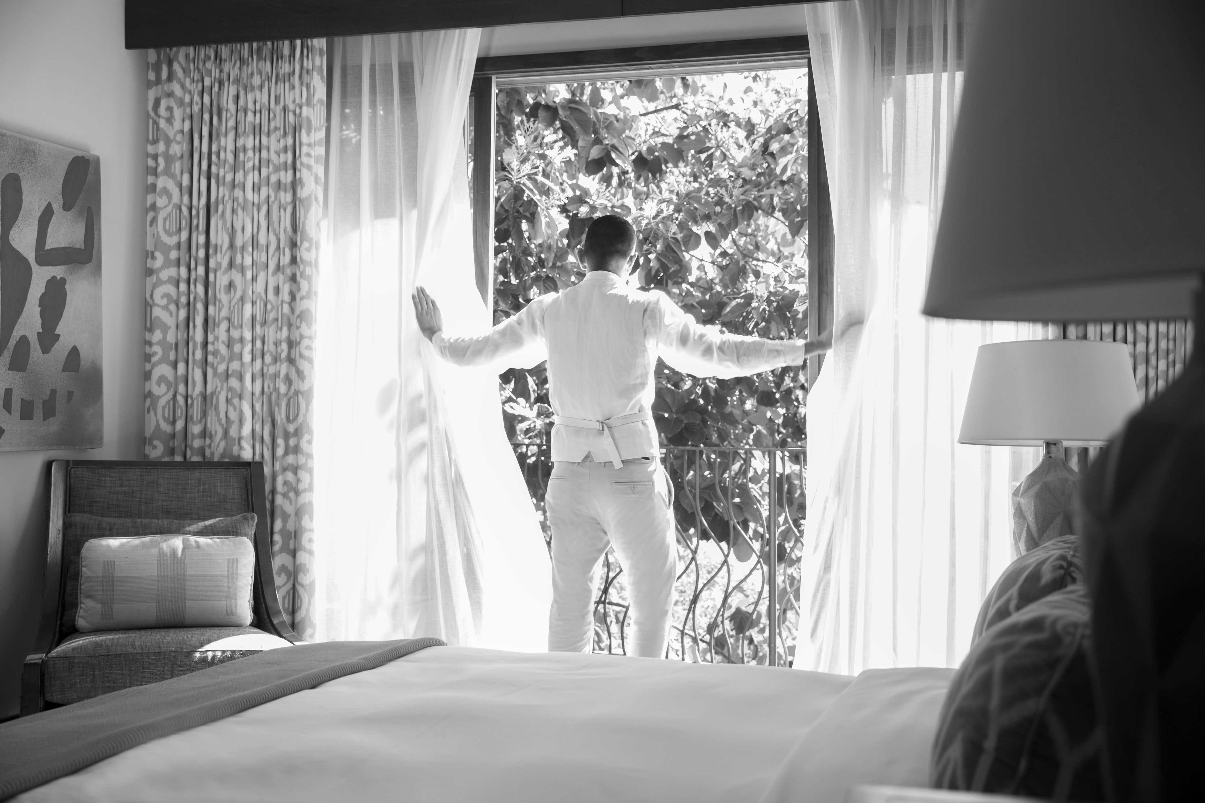 Man opening blinds.