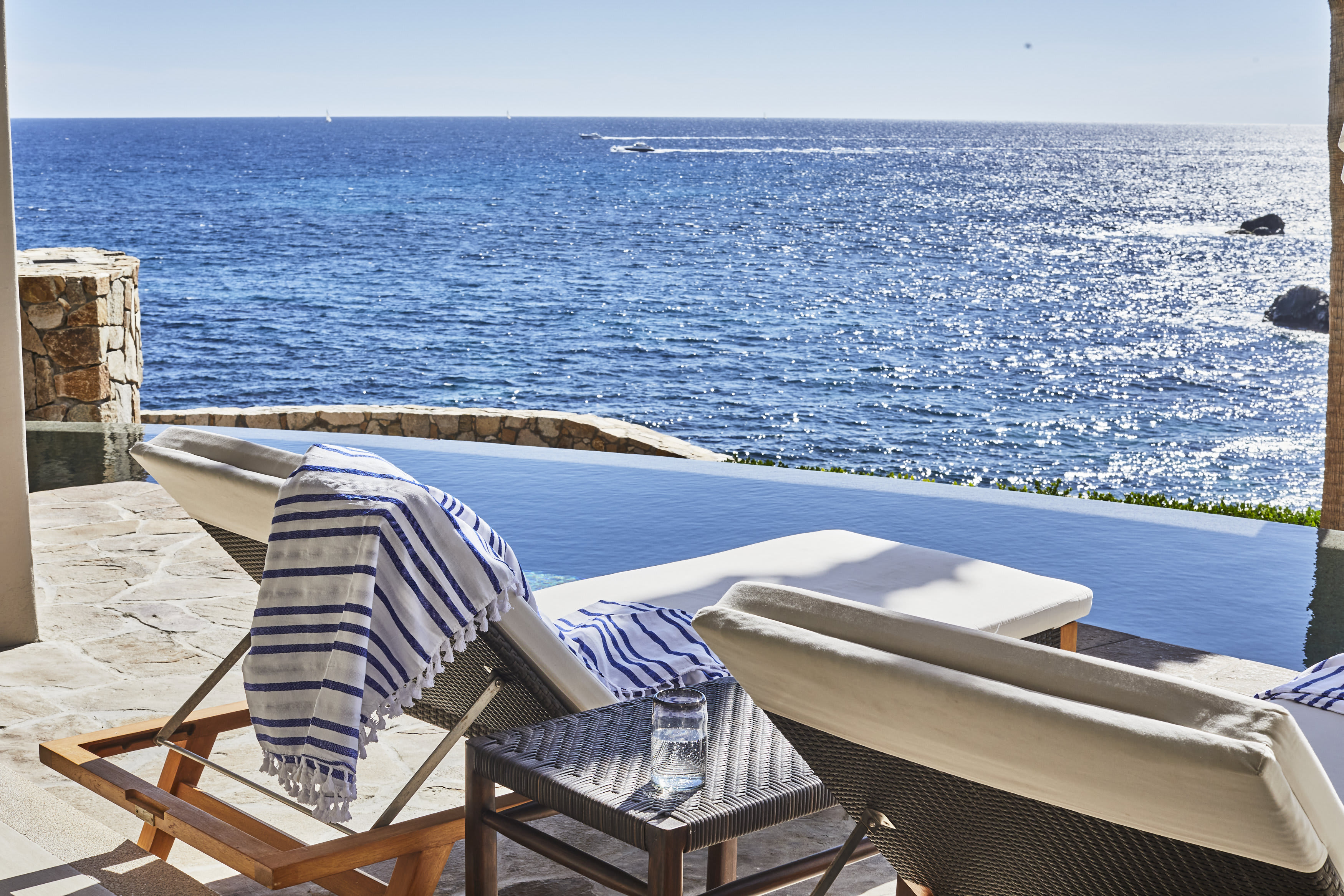 Two chairs by the pool overlooking the ocean in Los Cabos, Mexico.