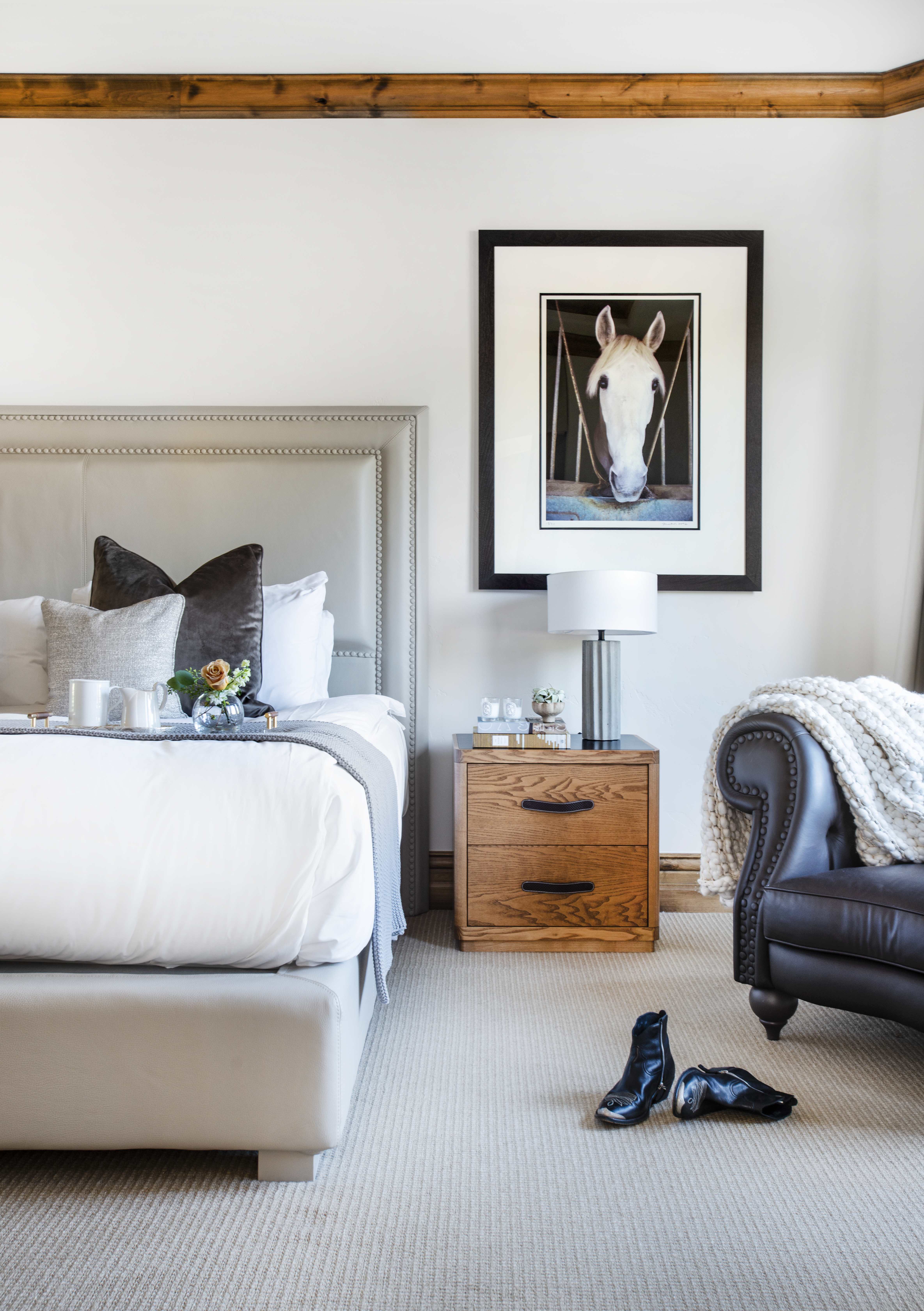 Exclusive Resorts property bedroom at The Arrabelle at Vail Square with equestrian-themed artwork and cozy decor.