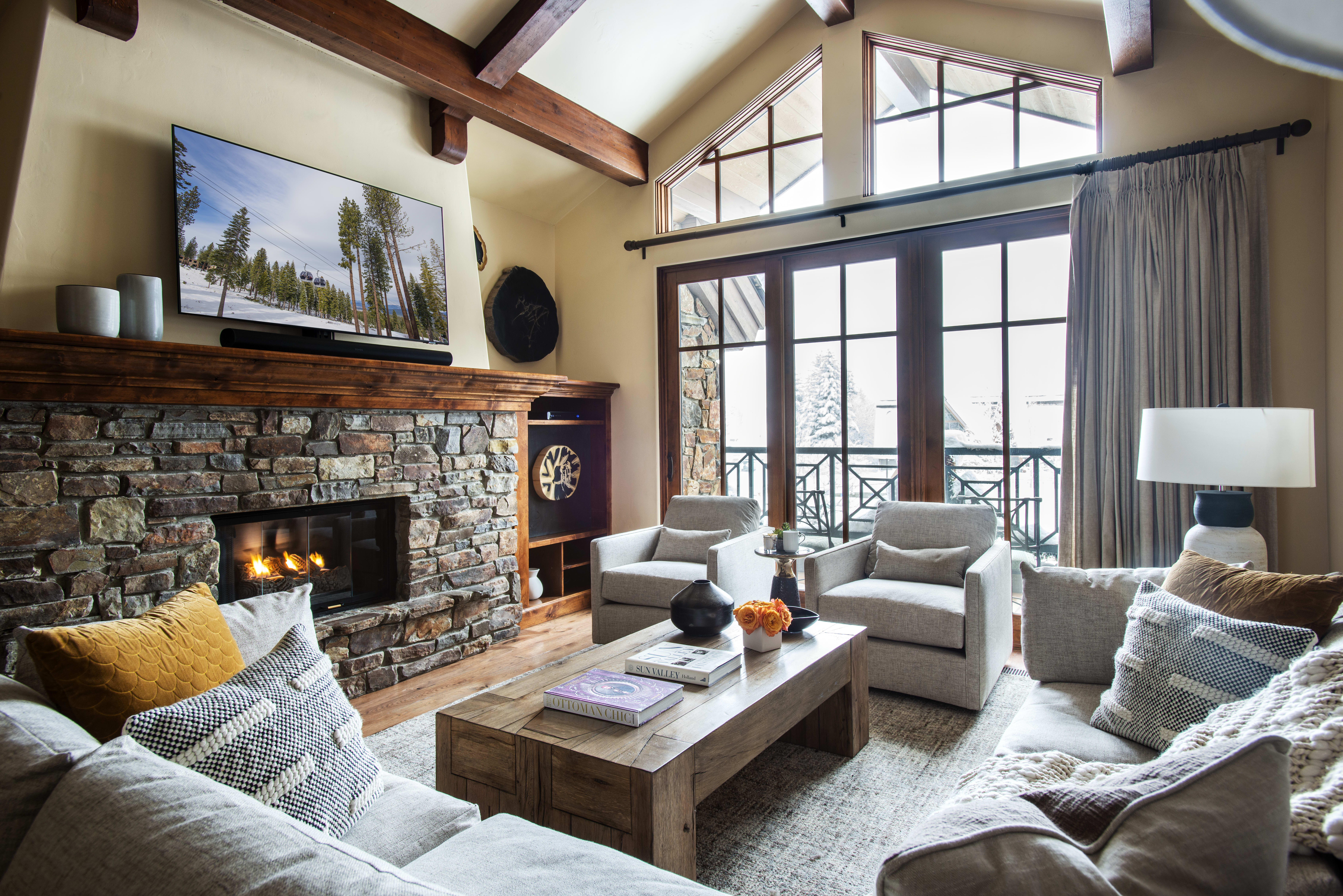 Inviting living room in Exclusive Resorts' Les Saisons property featuring a stone fireplace and plush seating in Sun Valley.
