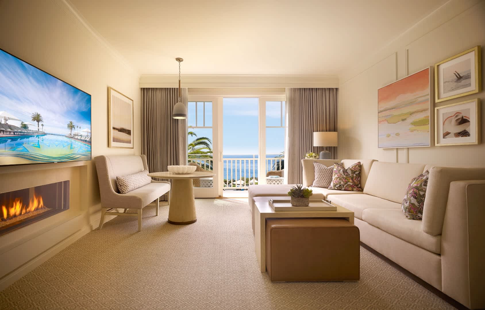 Exclusive Resorts' suite at Montage Laguna Beach with ocean view, modern decor, large windows, and comfortable seating.