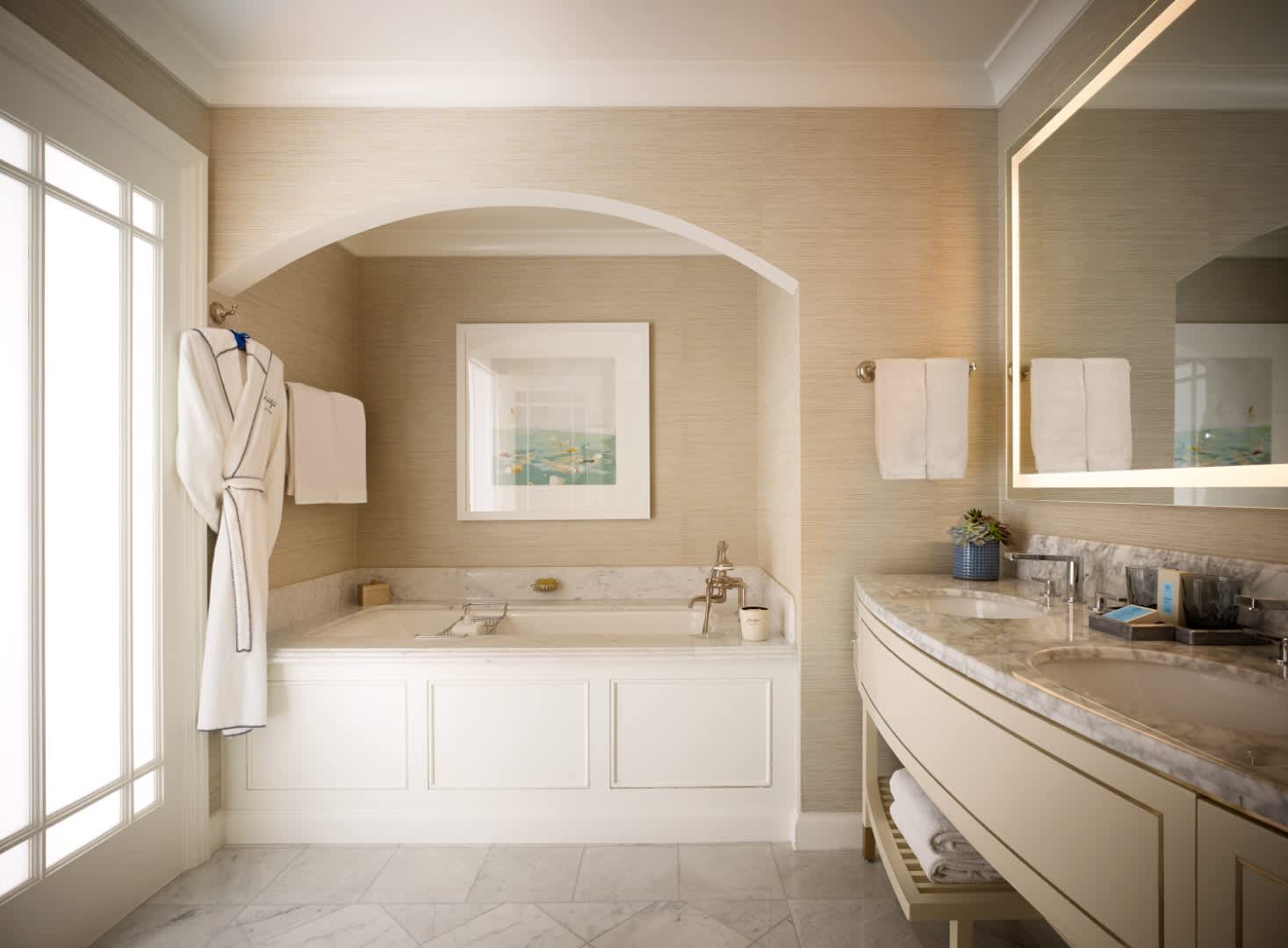 Exclusive Resorts' suite bathroom at Montage Laguna Beach with marble finishes, luxurious soaking tub, and elegant double vanity.