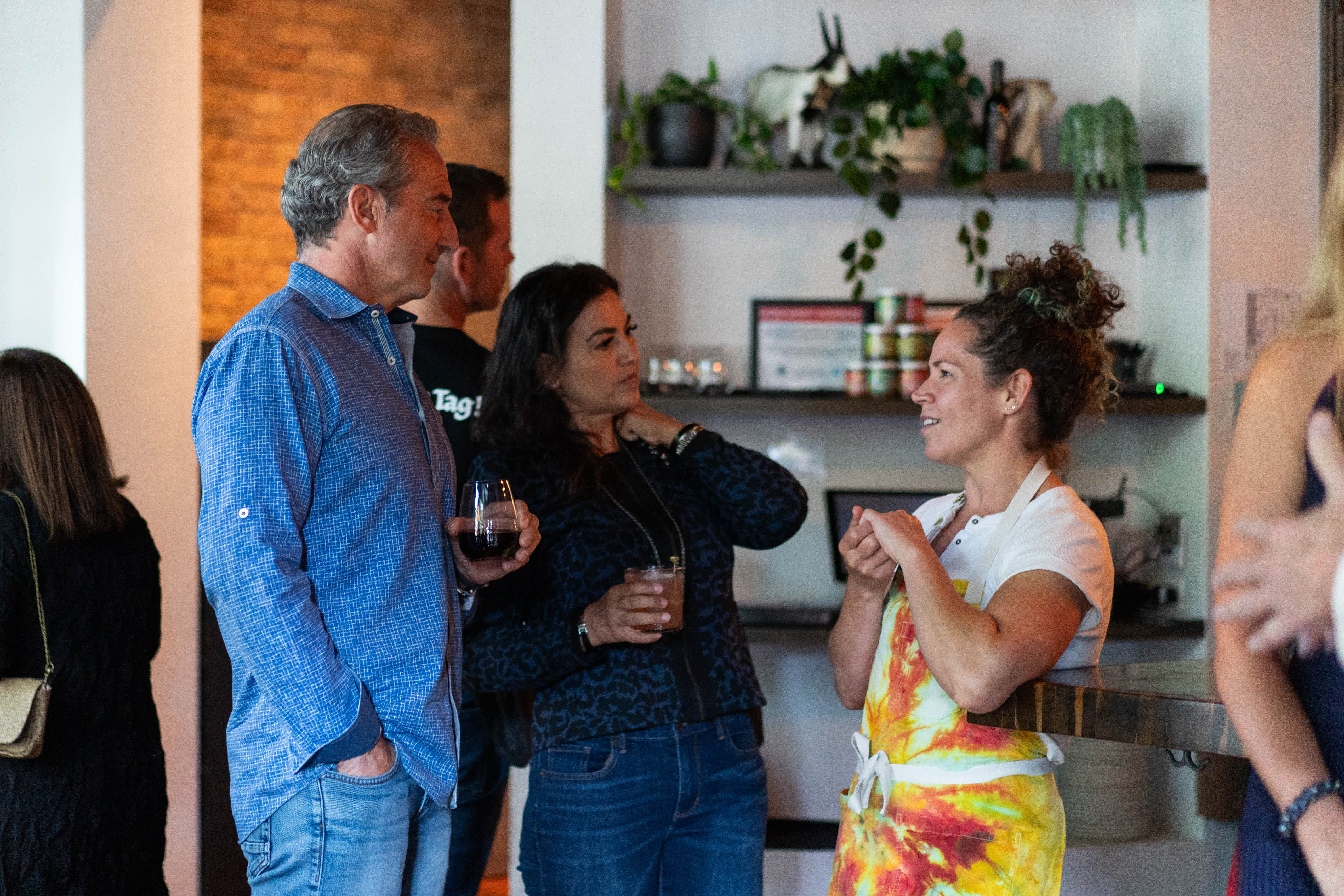 The Chef speaking with two Exclusive Resorts Members at a culinary event.