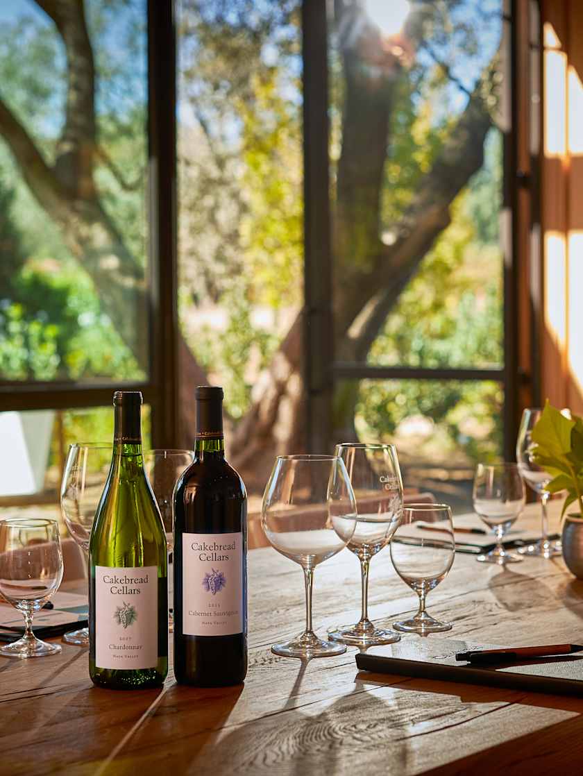 Indoor dining table set with wine bottles at Cakebread Cellars in Napa Valley.