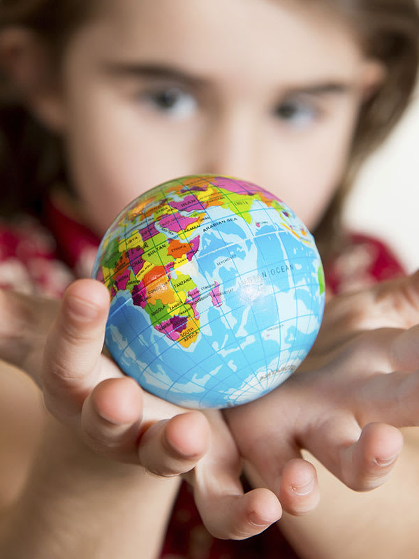 Little girl with a globe in her hands