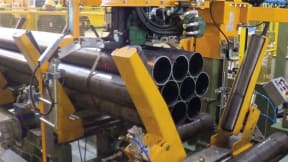 Metal tube packing machines and systems