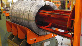 Compacting and strapping of big (bulk) coils of galvanized steel wire