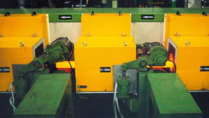 Induction heating systems for heat treatment of metal bars and billets