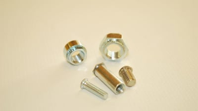 Self-anchoring studs and nuts for metal sheets