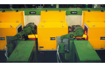 Induction heating systems for heat treatment of metal bars and billets
