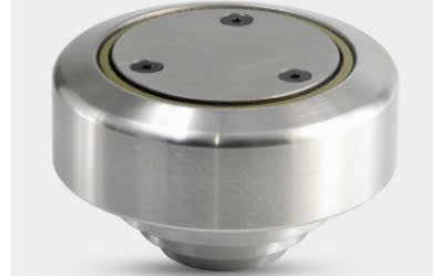 Brushed stainless steel roller or guide wheel with a recessed circular top plate, secured by three black hex screws, and a subtle golden inner ring.