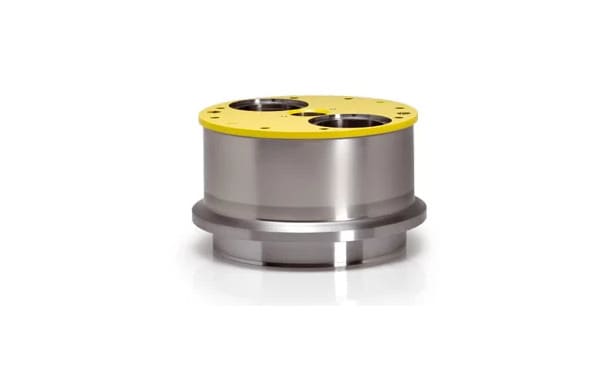 Stainless steel cylindrical industrial component with a bright yellow top cover featuring two large circular ports and multiple smaller bolt holes.