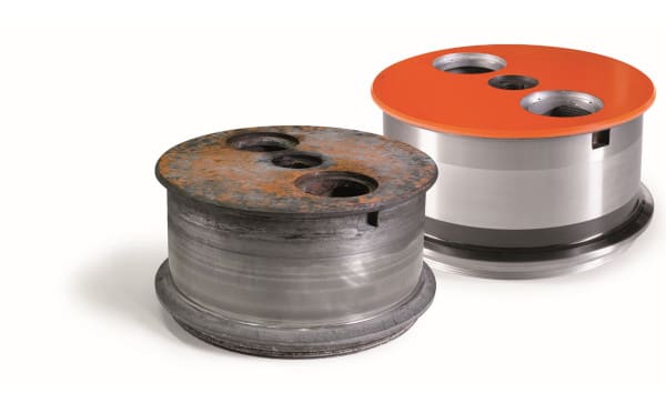 Corroded and worn industrial component with three holes, contrasted with a new, polished metal component with an orange top and matching holes.