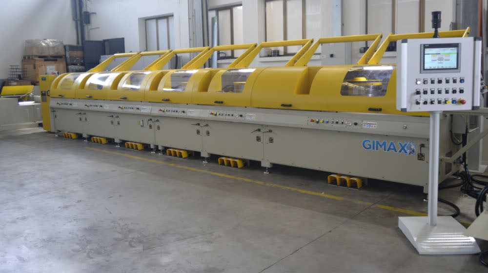 GIMAX yellow and grey industrial machine for wire processing with transparent covers and a control panel on a factory floor.