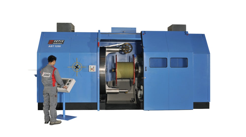 SETIC AST 1250 industrial cable winding machine with a technician operating the control panel.