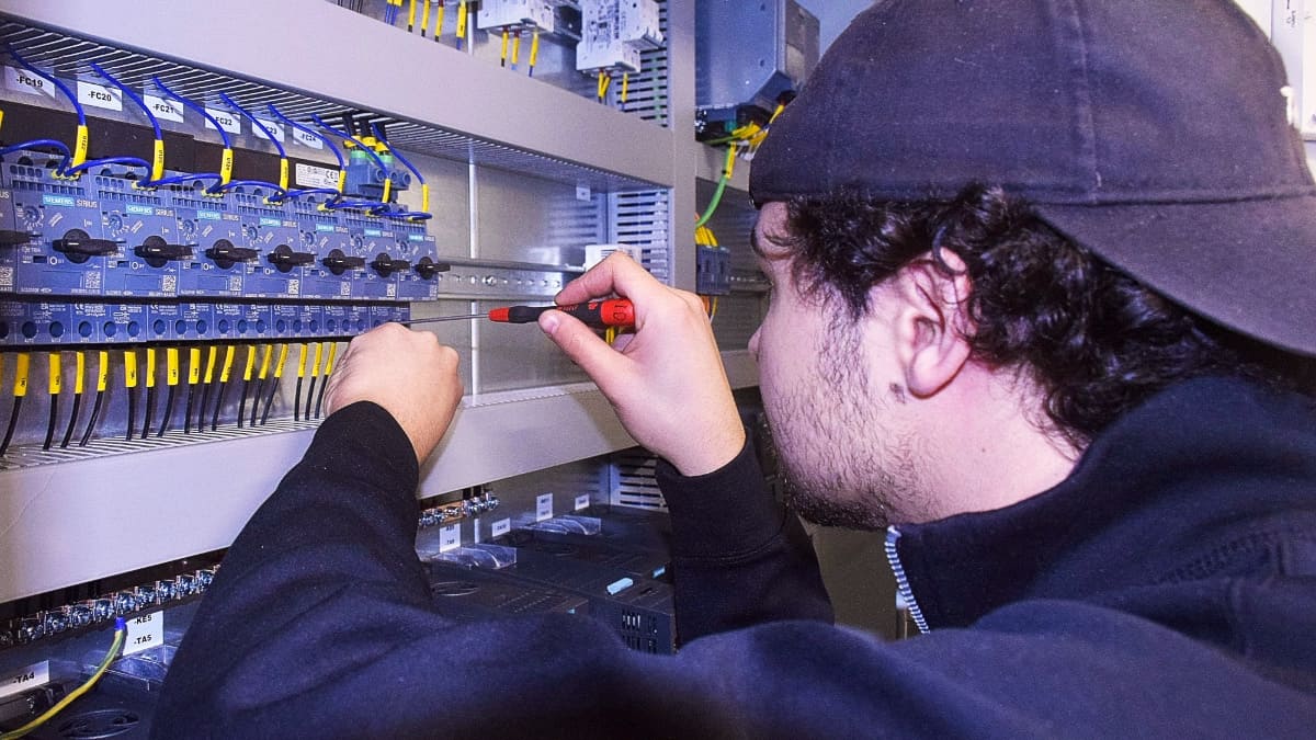 Lämneå Bruk technician assembling a custom electrical control panel at the Ljusfallshammar workshop