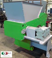 M.O.R.E. Recycling Technologies industrial shredder machine with a green main body, gray feeding hopper, and external drive system.